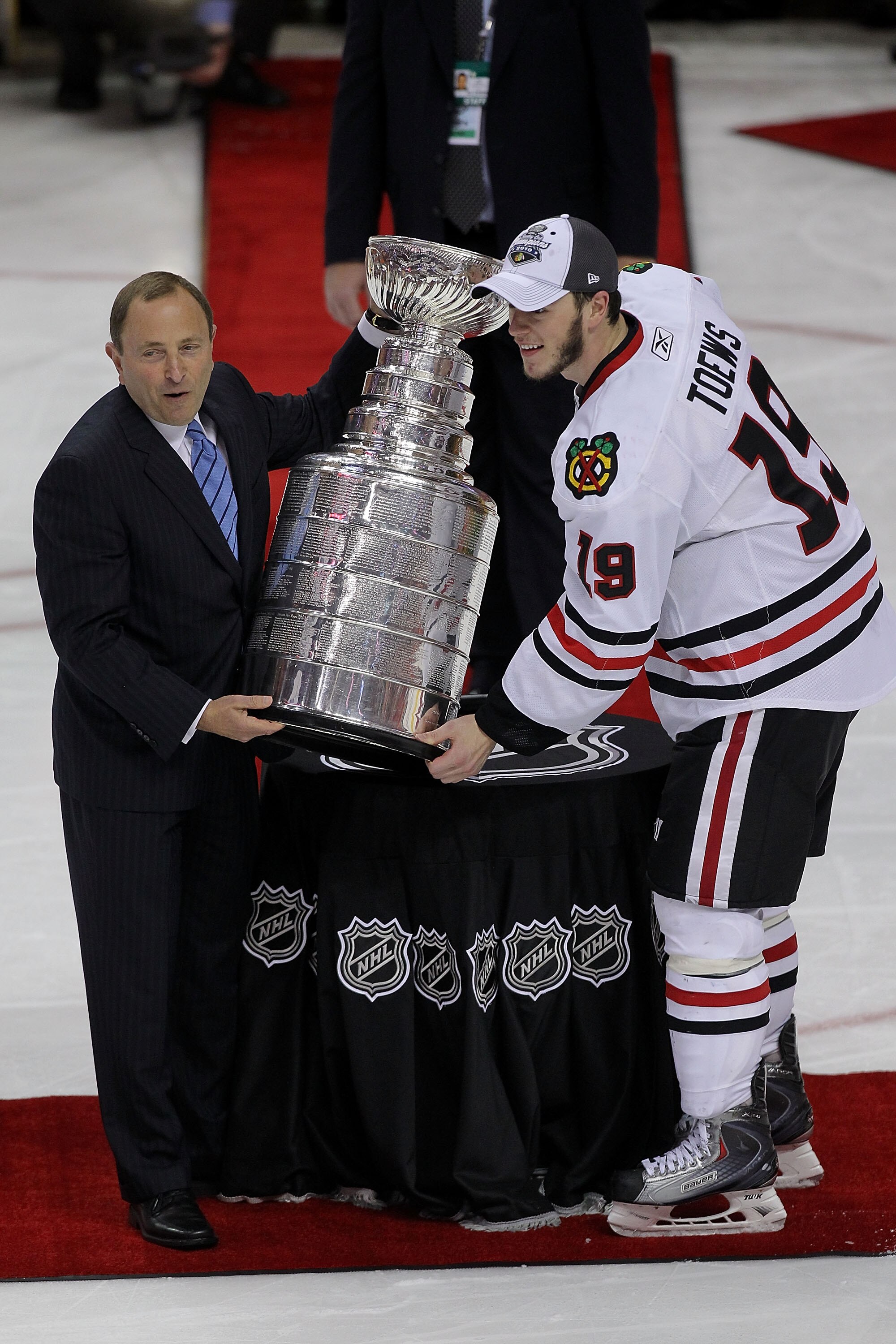 PHILADELPHIA - JUNE 09:  NHL Commissioner Gary Bettman presents Jonathan Toews #19 of the Chicago Blackhawks with the Stanley Cup after teammate Patrick Kane #88 scored the game-winning goal in overtime to defeat the Philadelphia Flyers 4-3 and win the St