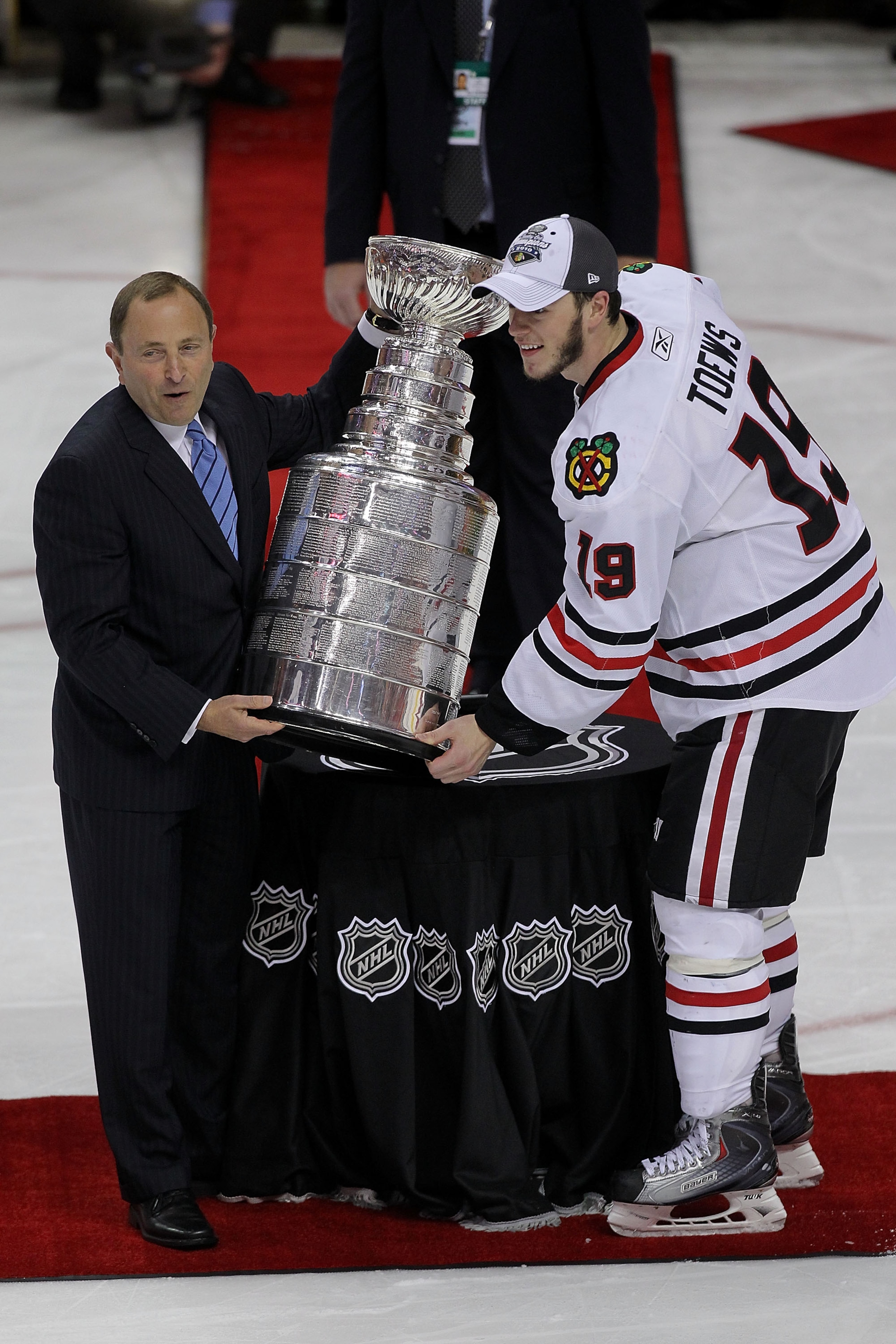 PHILADELPHIA - JUNE 09:  NHL Commissioner Gary Bettman presents Jonathan Toews #19 of the Chicago Blackhawks with the Stanley Cup after teammate Patrick Kane #88 scored the game-winning goal in overtime to defeat the Philadelphia Flyers 4-3 and win the St