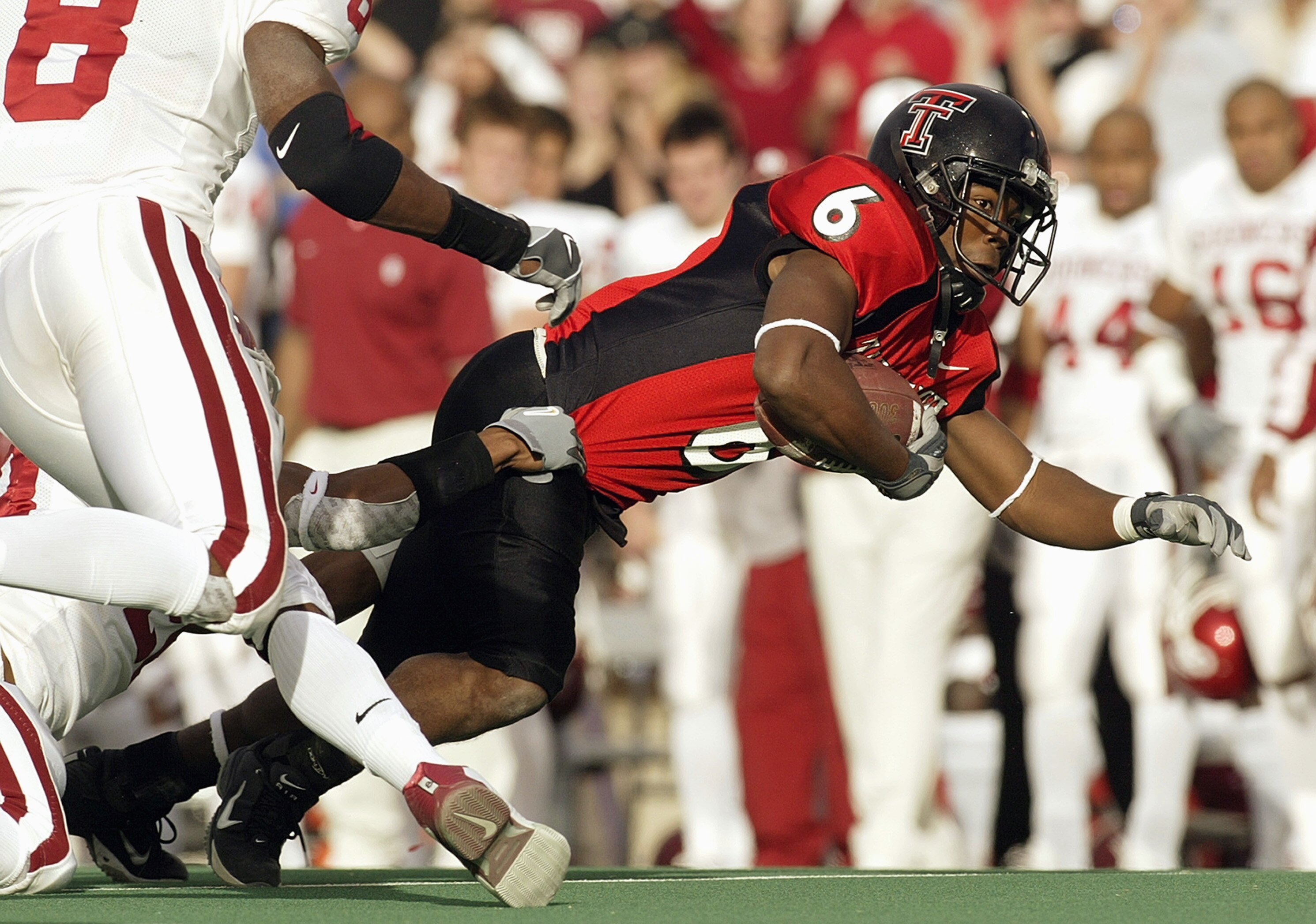 LUBBOCK, TX -NOVEMBER 22:  Wide receiver Nehemiah Glover #6 of the Texas Tech Red Raiders gets tackled during the game against the Oklahoma Sooners at Jones SBC Stadium on November 22, 2003 in Lubbock, Texas.  The Sooners won 56-25.  (Photo by Ronald Mart