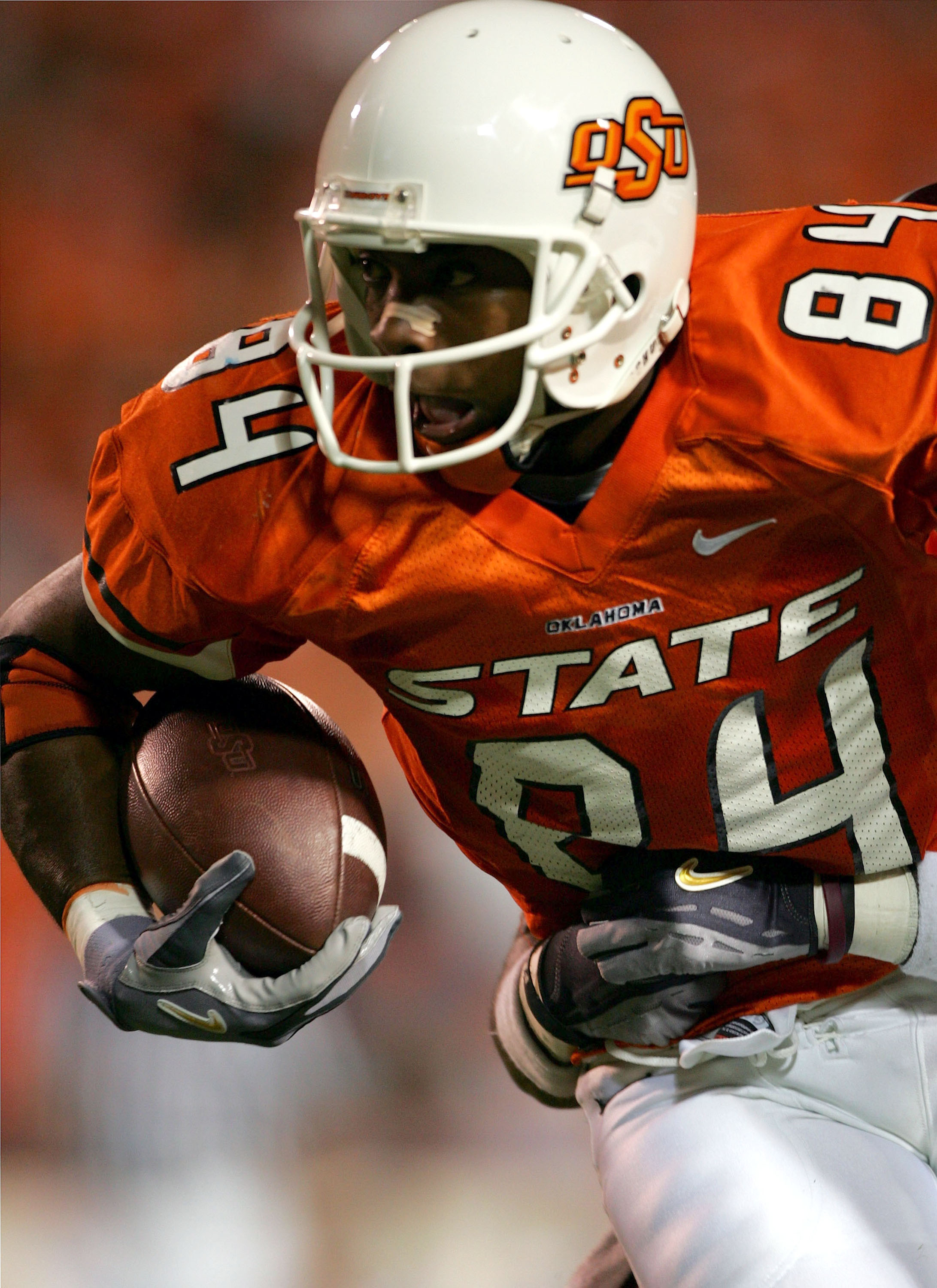 STILLWATER, OKLAHOMA - OCTOBER 16:  D'Juan Woods #84 of Oklahoma State is held from behind by the Texas A & M  defense in the second quarter at Boone Pickens Stadium on October 16, 2004 in Stillwater, Oklahoma. Texas A & M beat Oklahoma State 36-20. (Phot
