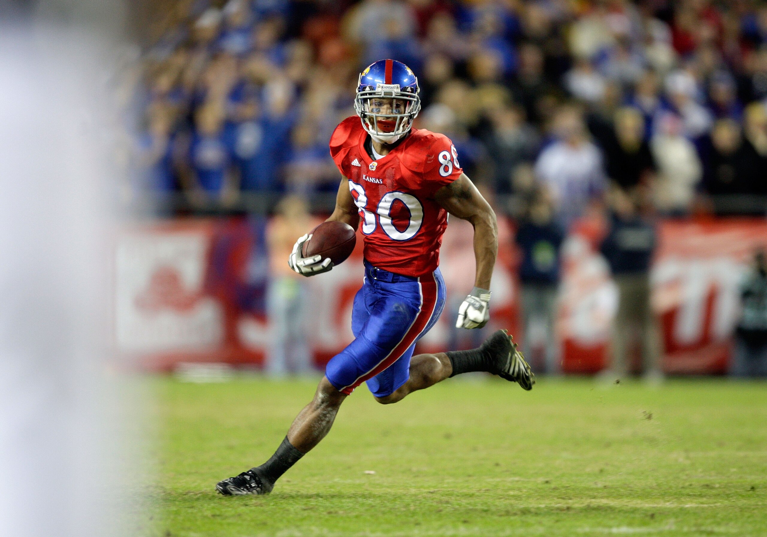 KANSAS CITY, MO - NOVEMBER 28:  Dezmon Briscoe #80 of the Kansas Jayhawks runs with the ball for yardage during their game against the Missouri Tigers during the game at Arrowhead Stadium on November 28, 2009 in Kansas City, Missouri. (Photo by Jamie Squi