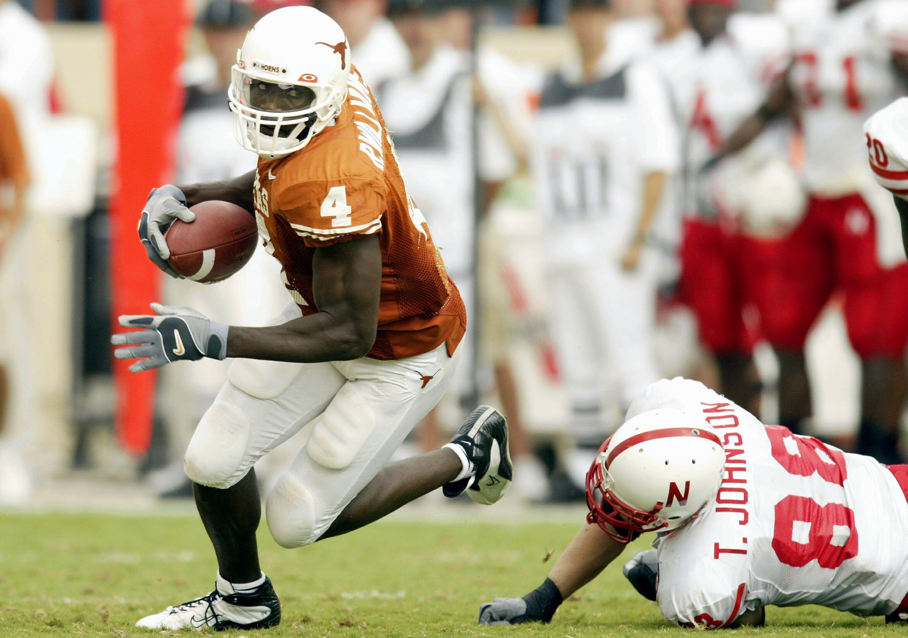 AUSTIN, TX - NOVEMBER 1:  Wider receiver Roy Williams #4 of the Texas Longhorns is tripped by Trevor Johnson #88 of the Nebraska Cornhuskers at Texas Memorial Stadium on November 1, 2003 in Austin, Texas.  The Longhorns defeated the Cornhuskers 31-7.  (Ph