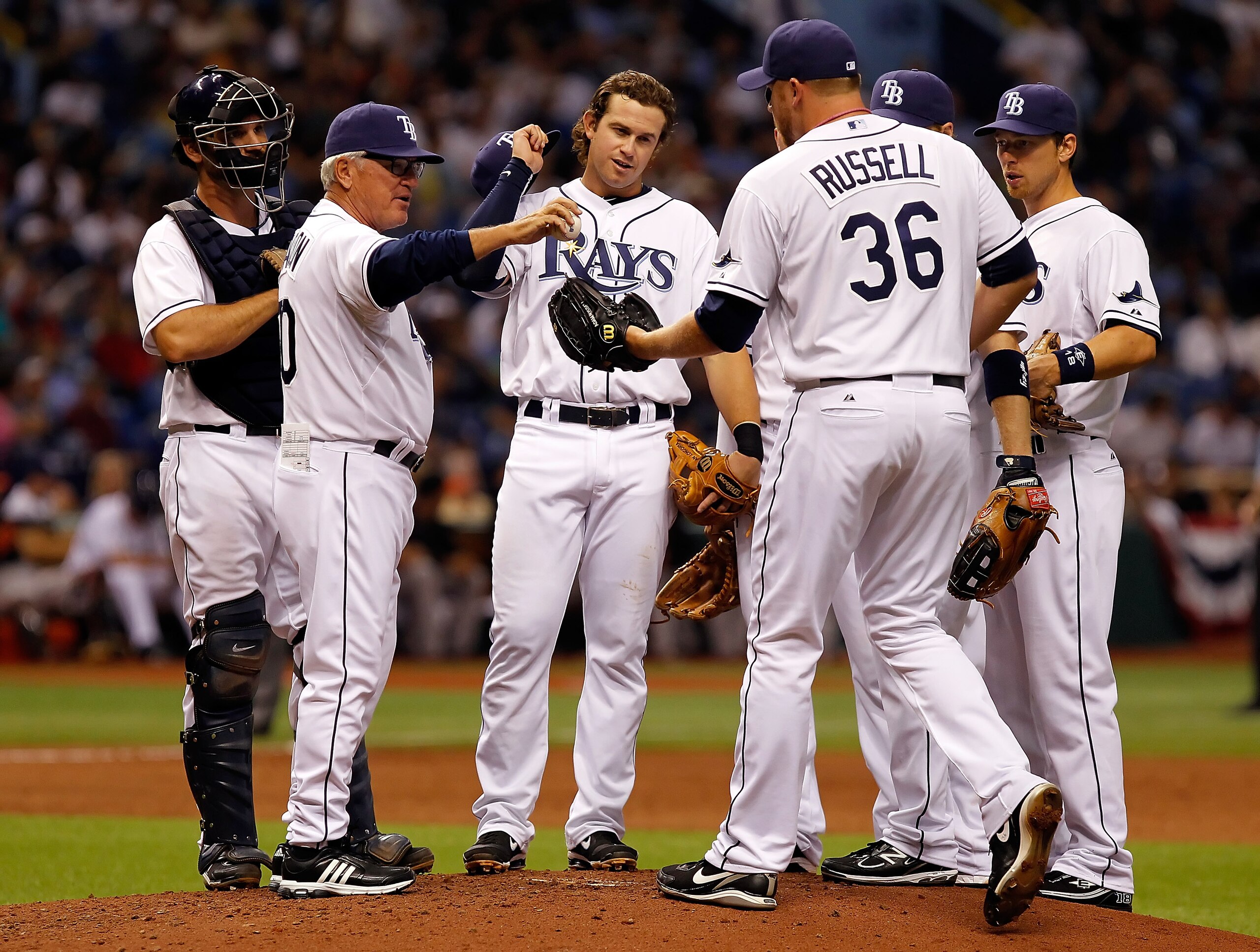 ST. PETERSBURG, FL - APRIL 01:  Manager Joe Maddon #70 of the Tampa Bay Rays brings in pitcher Adam Russell #36 against the Baltimore Orioles during the Opening Day game at Tropicana Field on April 1, 2011 in St. Petersburg, Florida.  (Photo by J. Meric/G