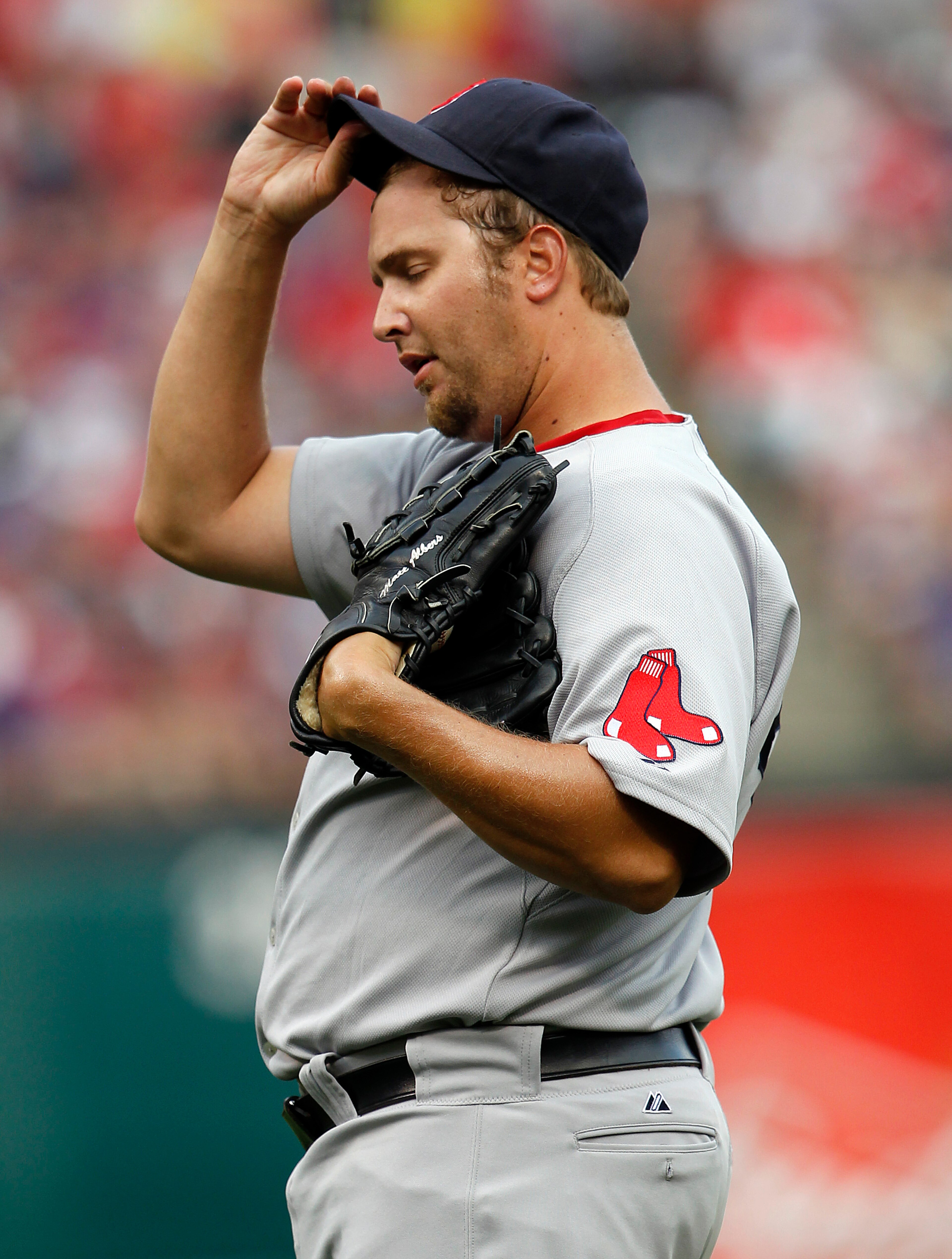 ARLINGTON, TX - APRIL 01:  Jon Lester #31 of the Boston Red Sox reacts after giving up a run against the Texas Rangers on Opening Day at Rangers Ballpark in Arlington on April 1, 2011 in Arlington, Texas.  (Photo by Tom Pennington/Getty Images)