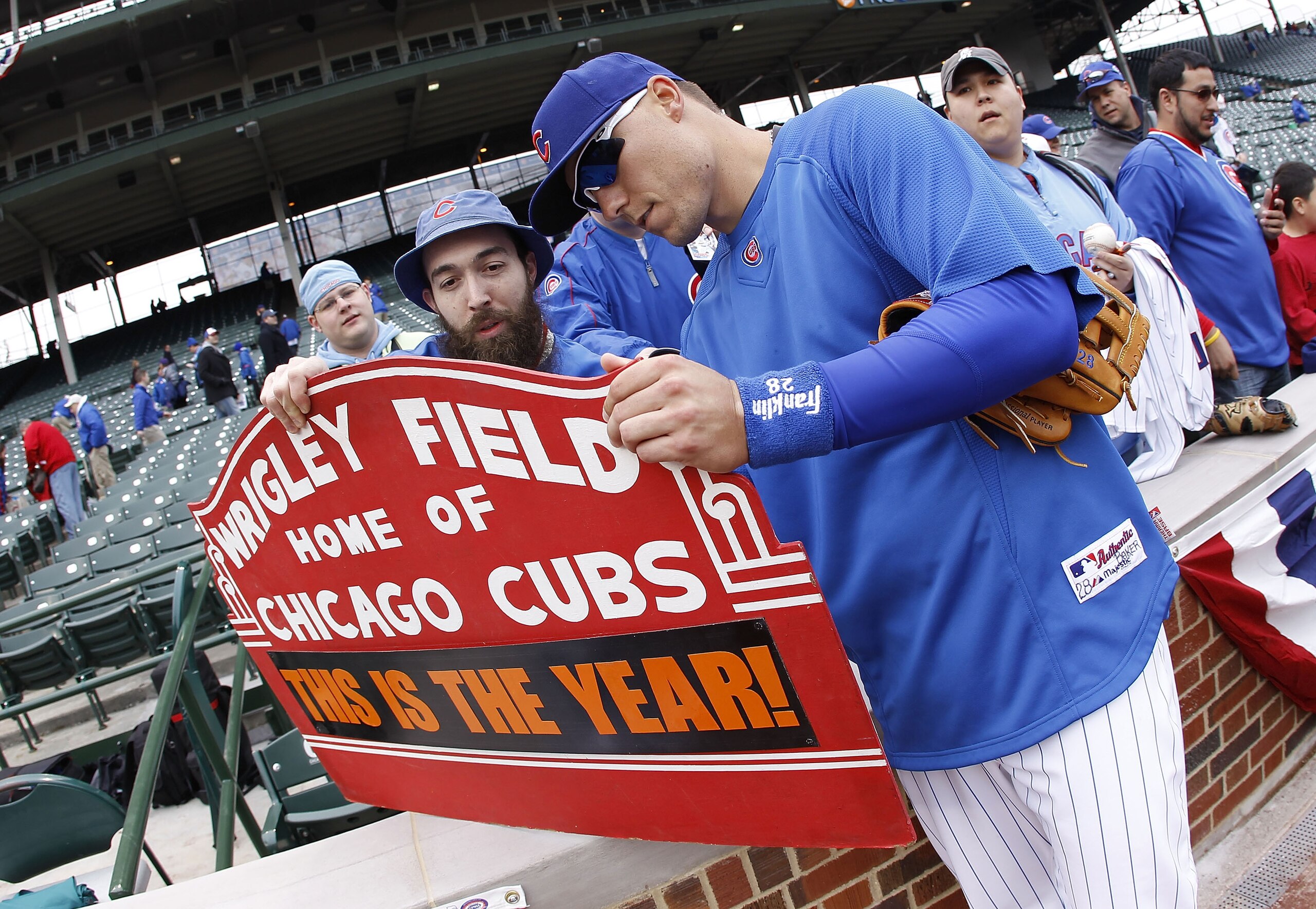 CHICAGO, IL - APRIL 01:  Jeff Baker #28 of the Chicago Cubs signs a autography prior to playing the Pittsburgh Pirates during opening day at Wrigley Field on April 1, 2011 in Chicago, Illinois.  (Photo by Gregory Shamus/Getty Images)