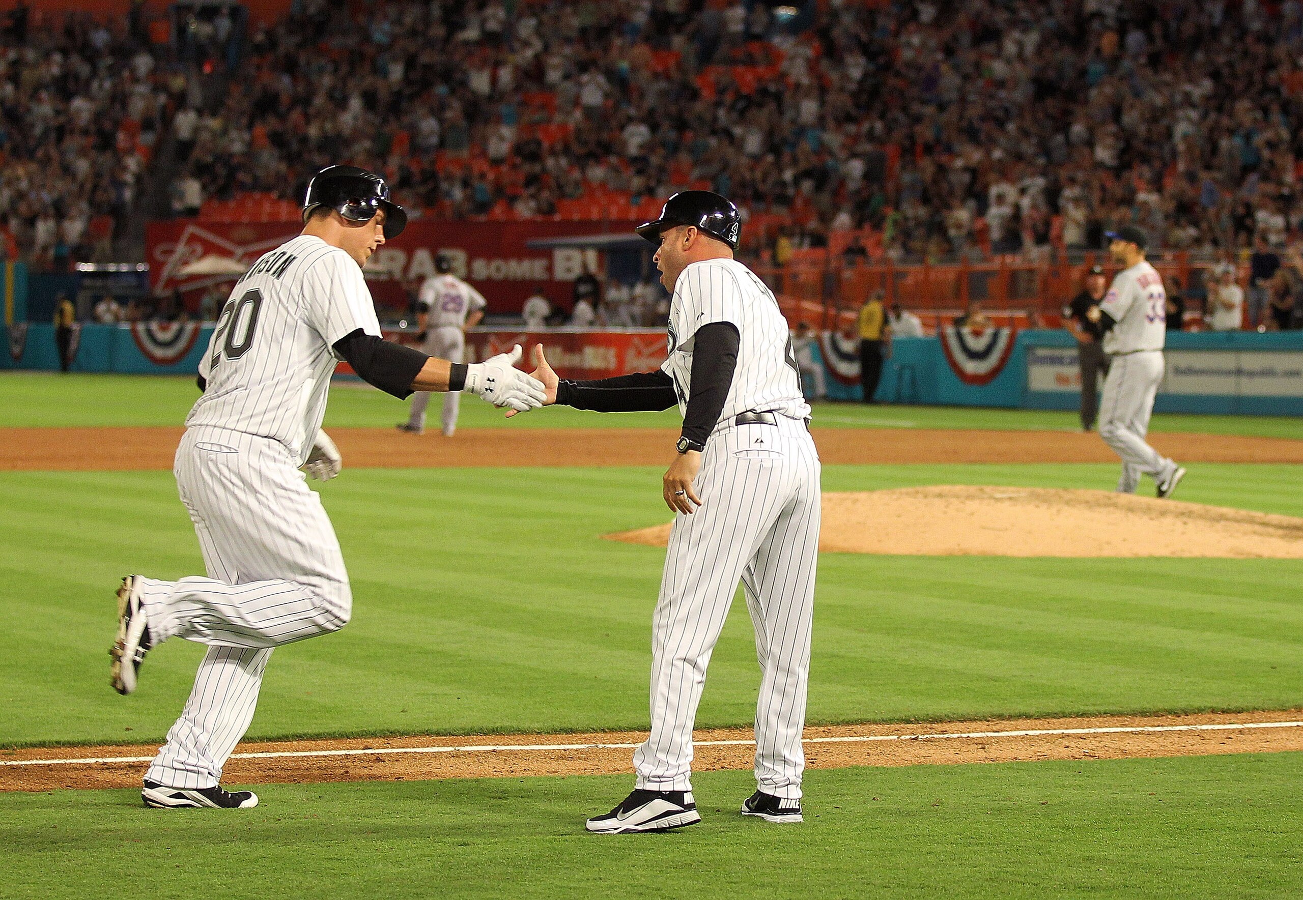 MIAMI GARDENS, FL - APRIL 01: Logan Morrison #20 of the Florida Marlins rounds third after hitting a home run off Taylor Buchholz #33 of the New York Mets during opening day  at Sun Life Stadium on April 1, 2011 in Miami Gardens, Florida.  (Photo by Mike