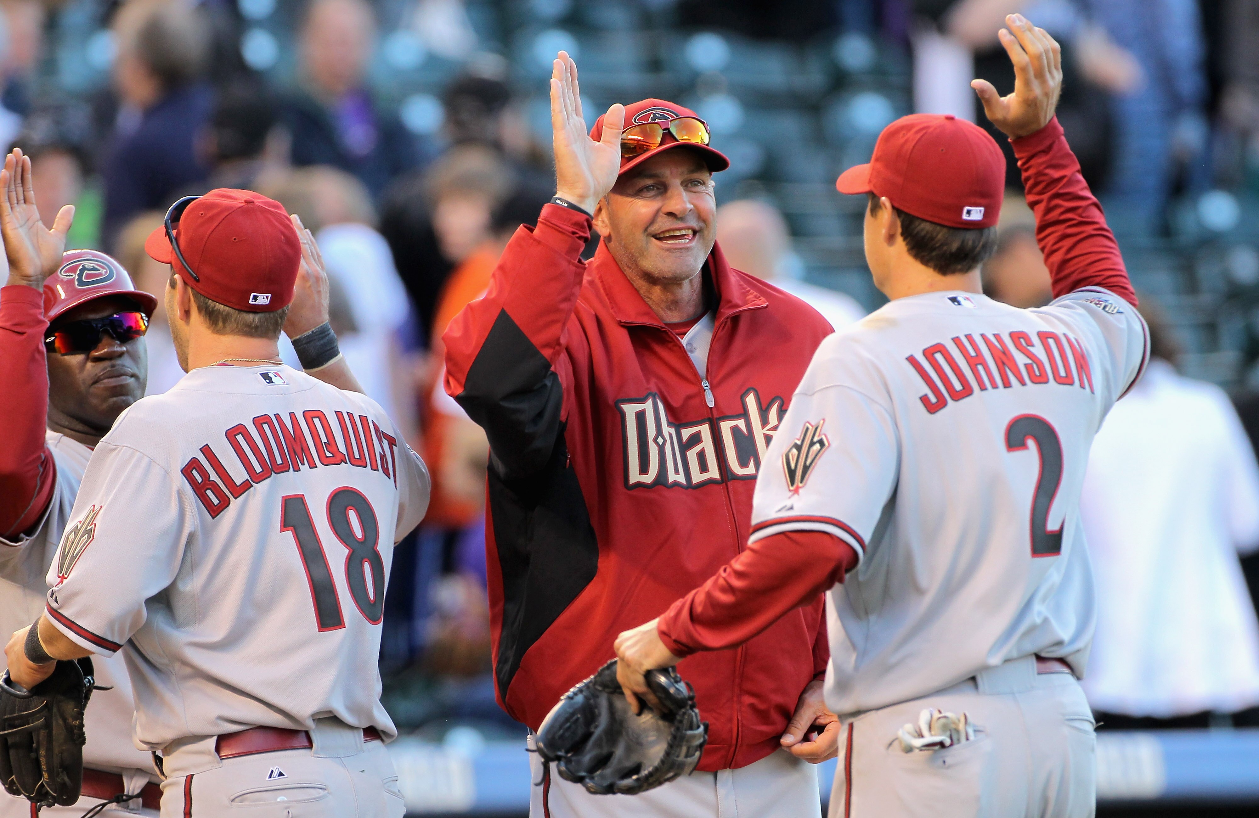 DENVER, CO - APRIL 01: Kelly Johnson #2 of the Arizona Diamondbacks is welcomed off the field by manager Kirk Gibson #23 and Willie Bloomquist #18 of the Arizona Diamondbacks is welcomed off the field by Eric Young of the Arizona Diamondbacks as they ce DENVER, CO - APRIL 01: Kelly Johnson #2 of the Arizona Diamondbacks is welcomed off the field by manager Kirk Gibson #23 and Willie Bloomquist #18 of the Arizona Diamondbacks is welcomed off the field by Eric Young of the Arizona Diamondbacks as they ce