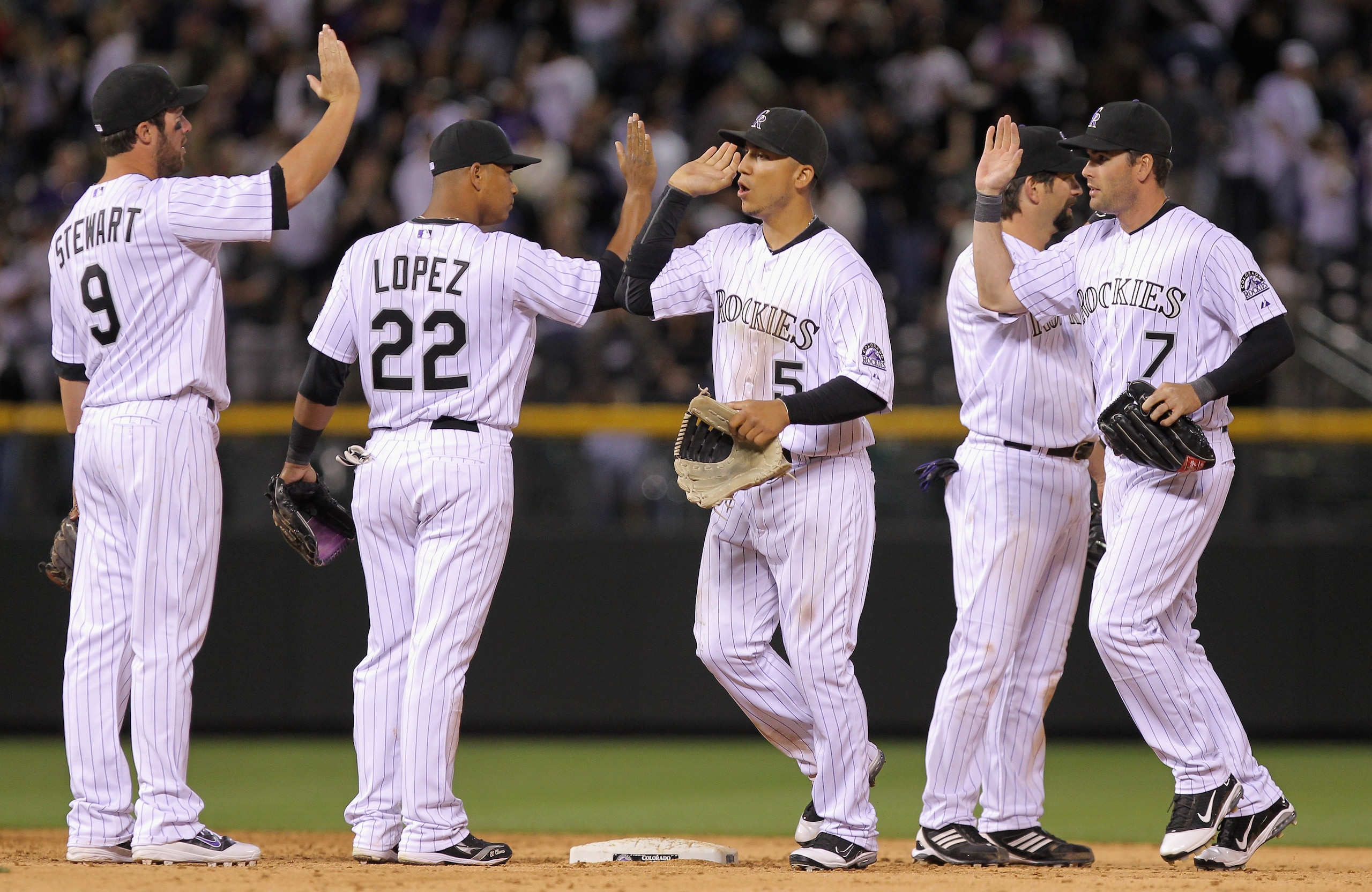 DENVER, CO - APRIL 02:  The Colorado Rockies celebrate their victory over the Arizona Diamondbacks at Coors Field on April 2, 2011 in Denver, Colorado. The Rockies defeated the Diamondbacks 3-1.  (Photo by Doug Pensinger/Getty Images)