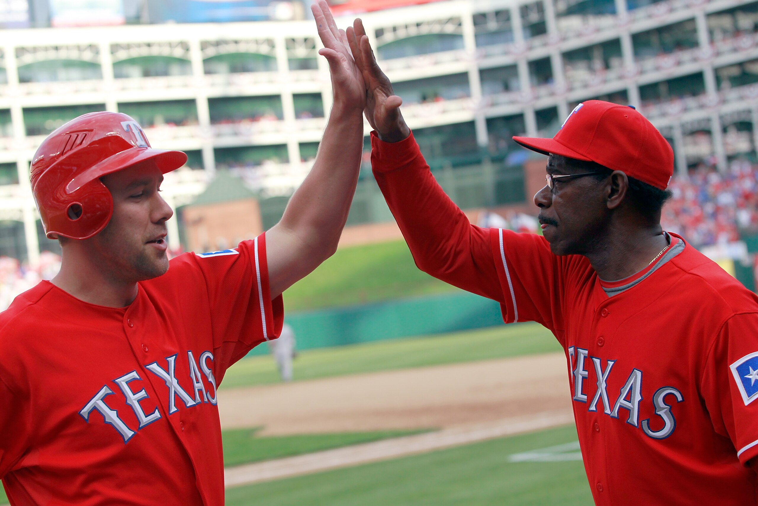 ARLINGTON, TX - APRIL 01:  David Murphy #7 of the Texas Rangers celebrates with Ron Washington Manager of the Texas Rangers after Hamilton hit the game winning RBI double in the bottom of the eighth inning against the Boston Red Sox on Opening Day at Rang