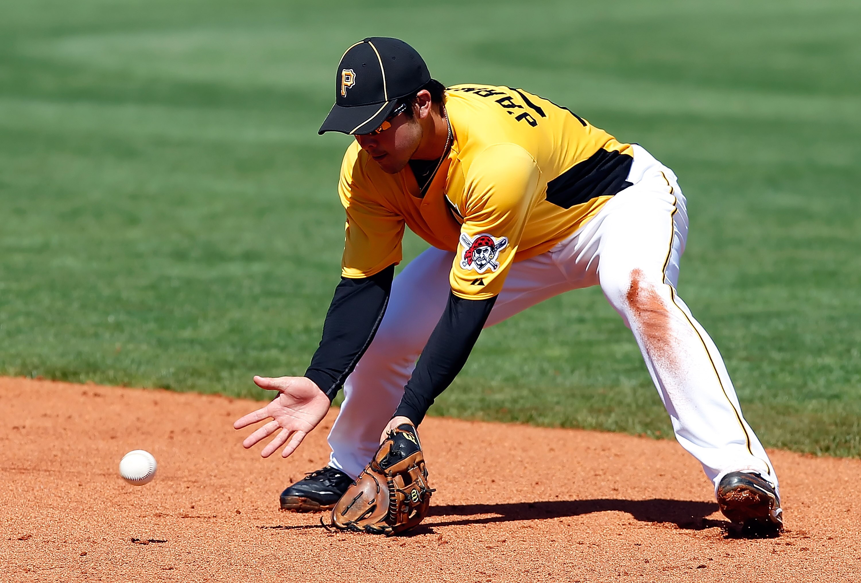 BRADENTON, FL - FEBRUARY 28:  Infielder Chase d'Arnaud #79 of the Pittsburgh Pirates fields a ground ball against the Baltimore Orioles during a Grapefruit League Spring Training Game at McKechnie Field on February 28, 2011 in Bradenton, Florida.  (Photo