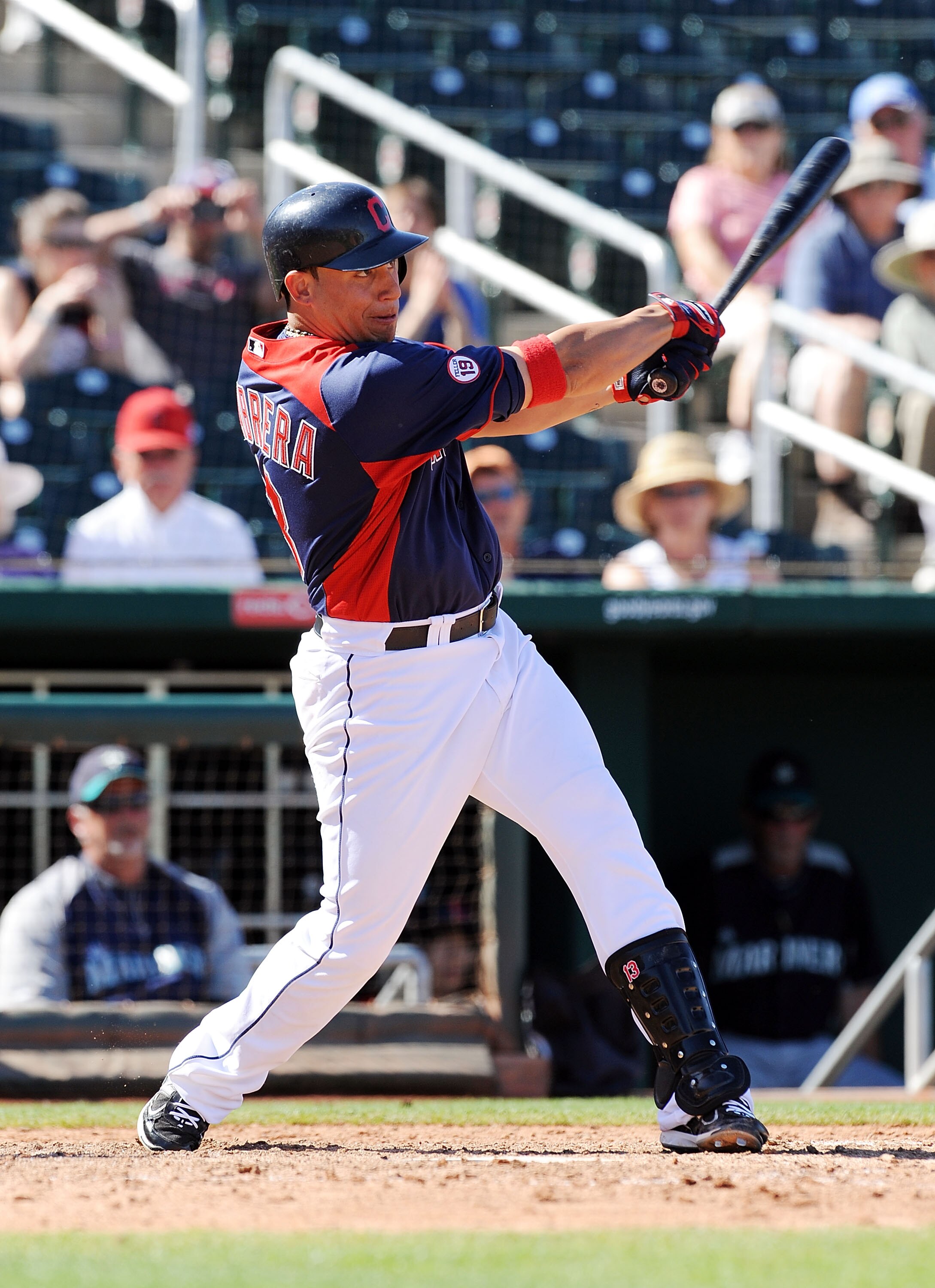 GOODYEAR, AZ - MARCH 11:  Asdrubal Cabrera #13 of the Cleveland Indians follows through on a swing against the Seattle Mariners at Goodyear Ballpark on March 11, 2011 in Goodyear, Arizona.  (Photo by Norm Hall/Getty Images)