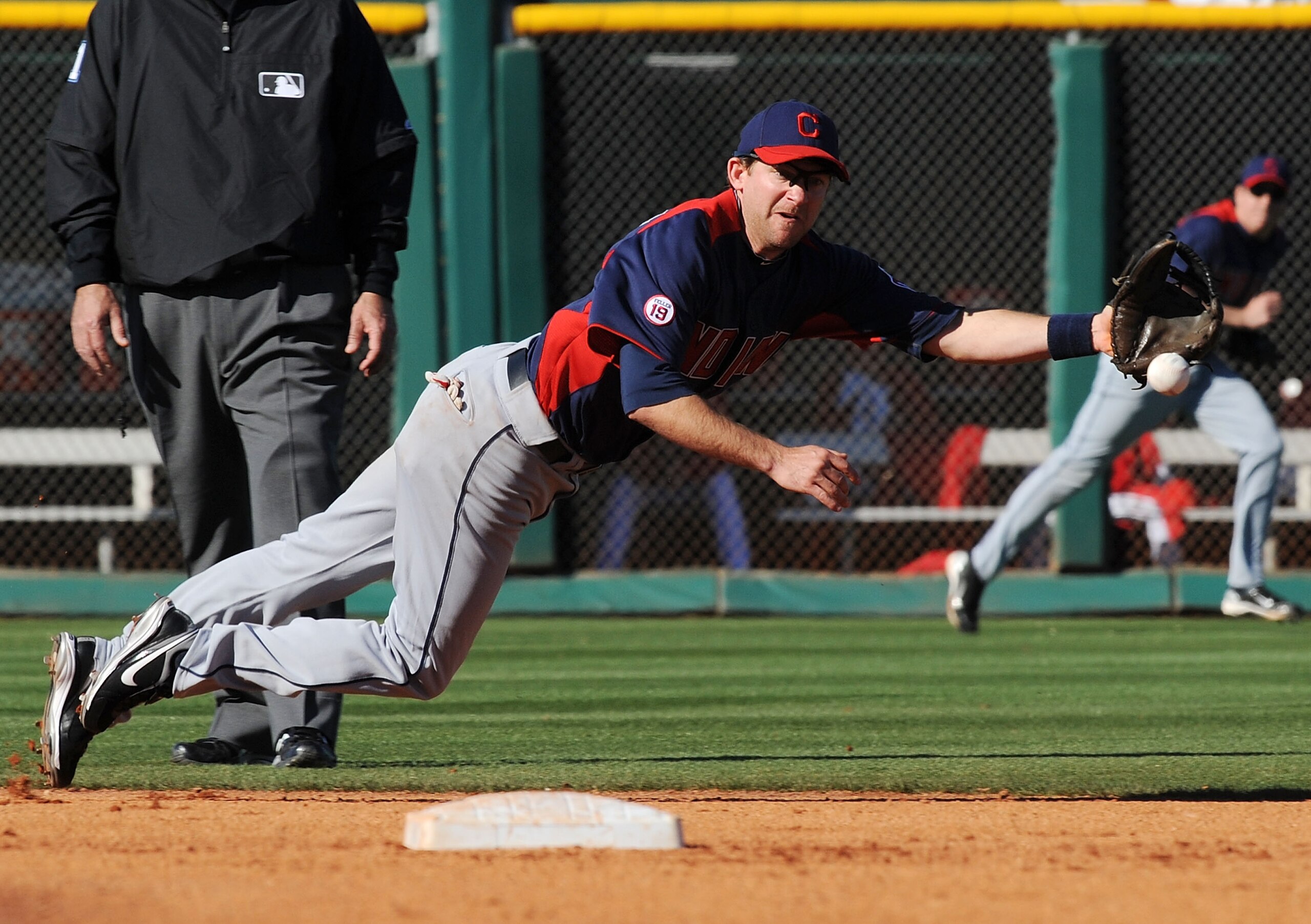GOODYEAR, AZ - FEBRUARY 28:  Adam Everett #8 of the Cleveland Indians dives for a ground ball against the Cleveland Indians at Goodyear Ballpark on February 28, 2011 in Goodyear, Arizona.  (Photo by Norm Hall/Getty Images)