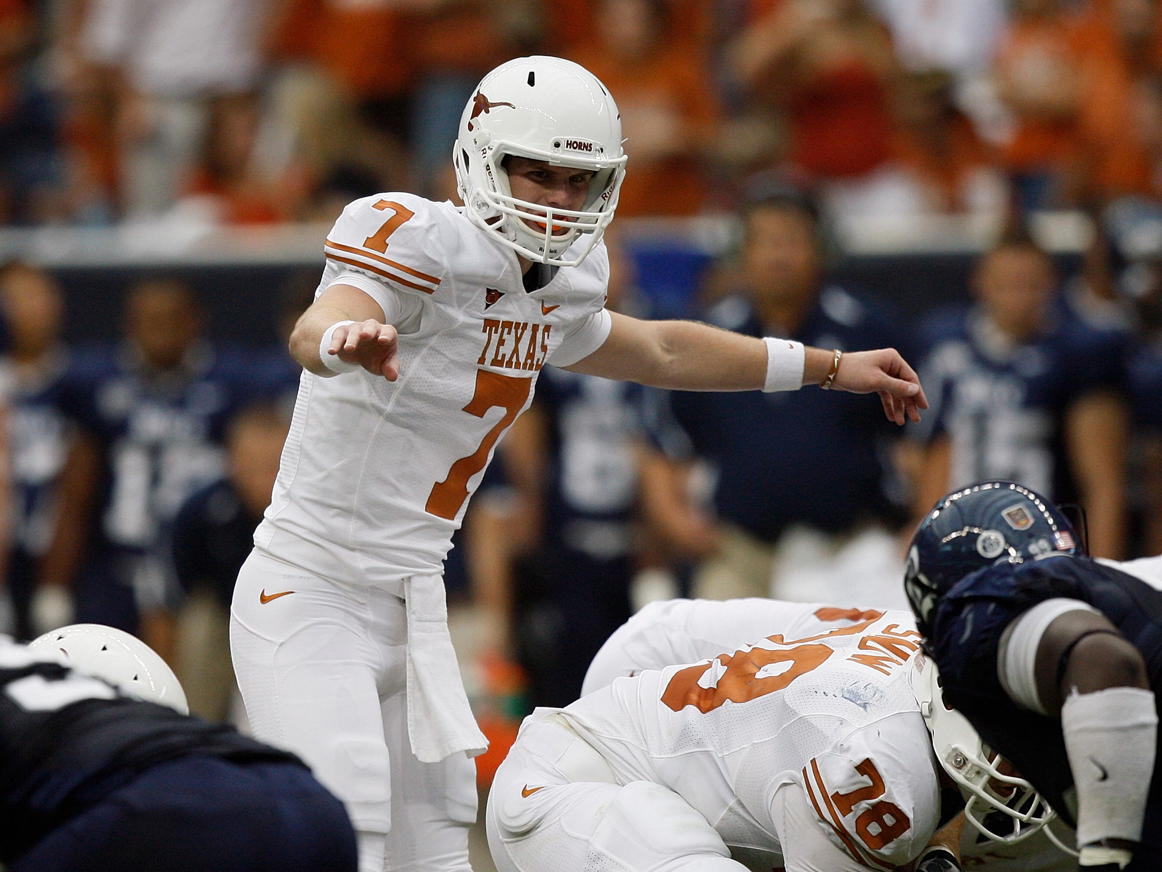 HOUSTON - SEPTEMBER 04: Quarterback Garrett Gilbert #7 of the Texas Lonhgorns changes the pplay at the line of scrimmage during a football game agasint the Rice Owls at Reliant Stadium on September 4, 2010 in Houston, Texas. Texas beat Rice 34-17. (Phot HOUSTON - SEPTEMBER 04: Quarterback Garrett Gilbert #7 of the Texas Lonhgorns changes the pplay at the line of scrimmage during a football game agasint the Rice Owls at Reliant Stadium on September 4, 2010 in Houston, Texas. Texas beat Rice 34-17. (Phot