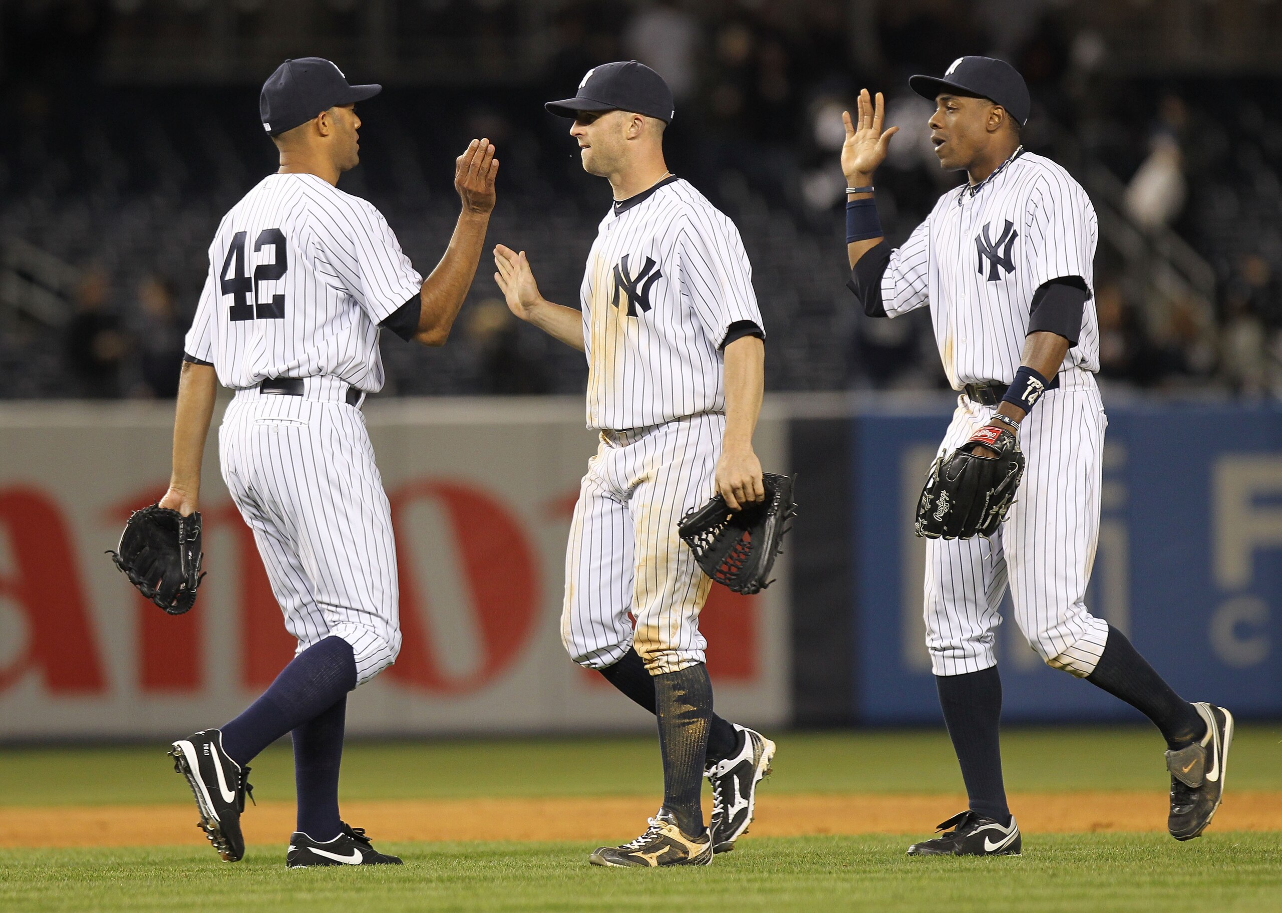 NEW YORK, NY - APRIL 02:  Mariano Rivera #42 of the New York Yankees celebrates the win with teammates Brett Gardner #11 and Curtis Granderson #14  against the Detroit Tigers at Yankee Stadium on April 2, 2011 in the Bronx borough of New York City.  (Phot