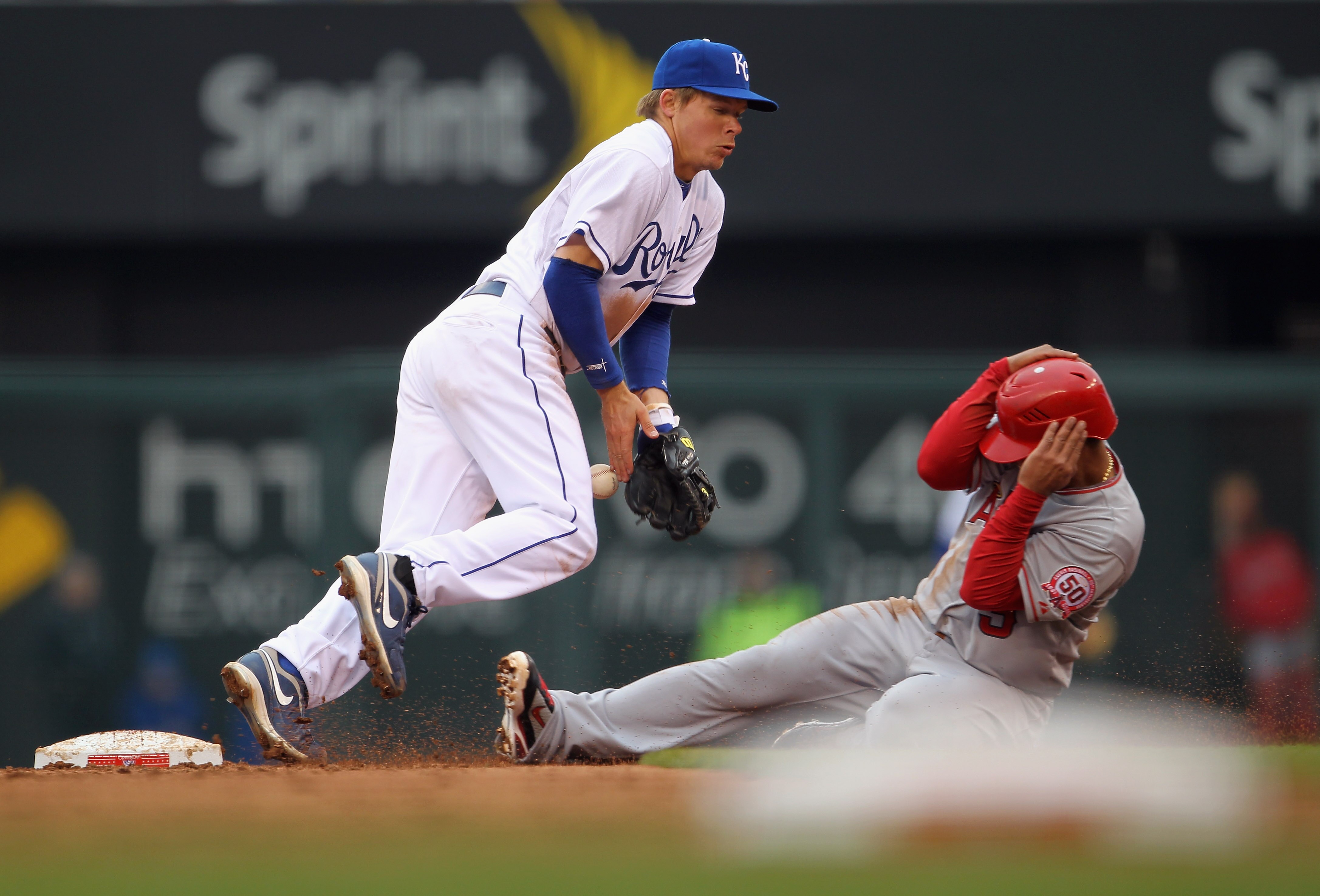 KANSAS CITY, MO - MARCH 31: Second-baseman Chris Getz #17 of the Kansas City Royals bobbles the ball as Maicer Izturis #13 of the Los Angeles Angels of Anaheim slides safely into second during the opening day game at Kauffman Stadium on March 31, 2011 in