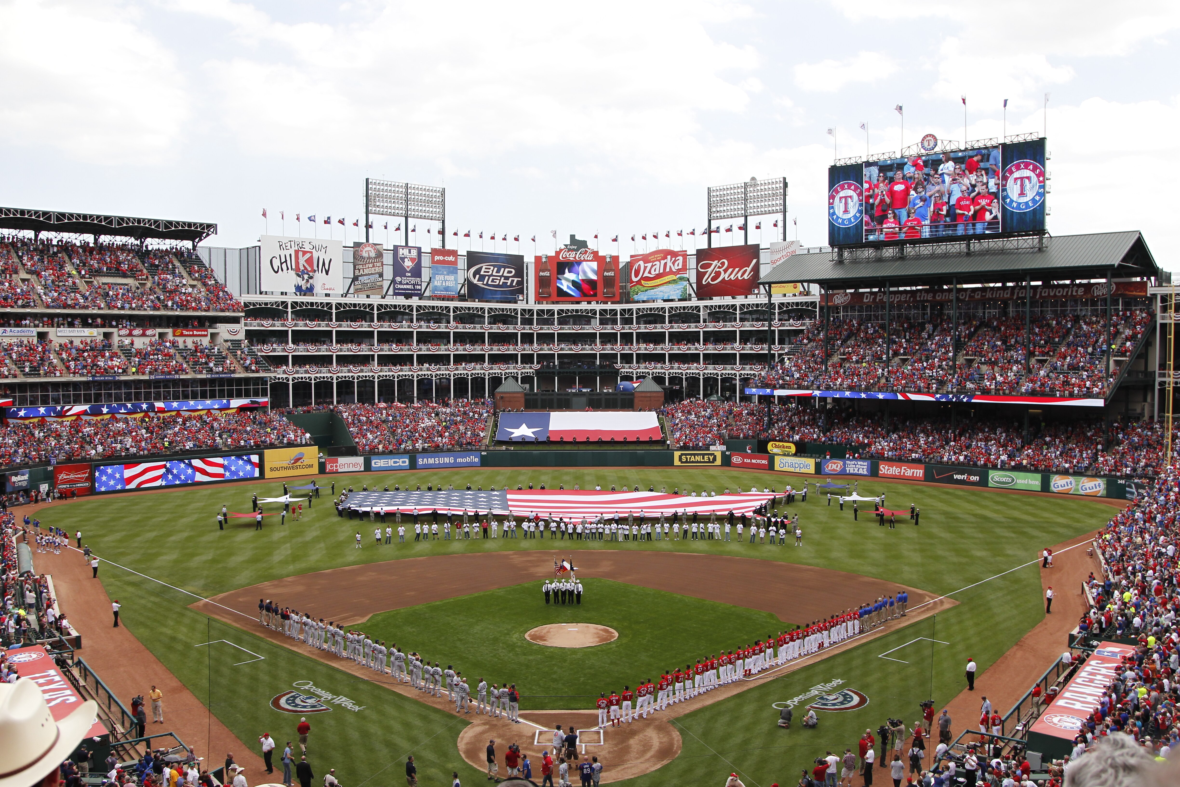 ARLINGTON, TX - APRIL 01:  The Texas Rangers and Boston Red Sox stand during the National Anthem on Opening Day at Rangers Ballpark in Arlington on April 1, 2011 in Arlington, Texas.  (Photo by Tom Pennington/Getty Images)