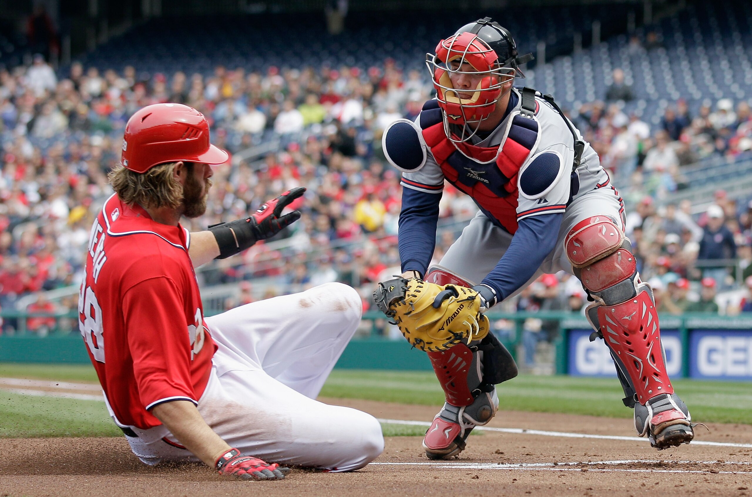 WASHINGTON, DC - APRIL 03: Catcher Brian McCann #16 of the Atlanta Braves tags out Jayson Werth #28 of the Washington Nationals at home plate during the at Nationals Park on April 3, 2011 in Washington, DC. Werth was credited with a run on the play due to