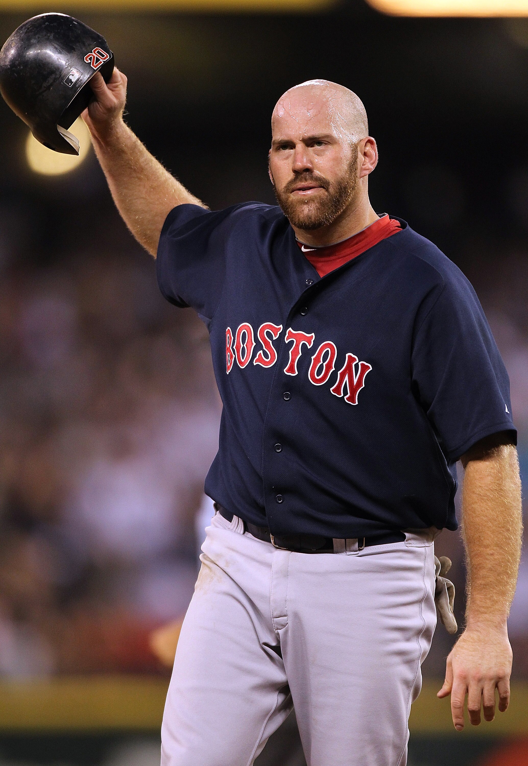 SEATTLE - JULY 24:  Kevin Youkilis #20 of the Boston Red Sox removes his helmet after the Red Sox were retired in the eighth inning with two runners on against the Seattle Mariners at Safeco Field on July 24, 2010 in Seattle, Washington. (Photo by Otto Gr
