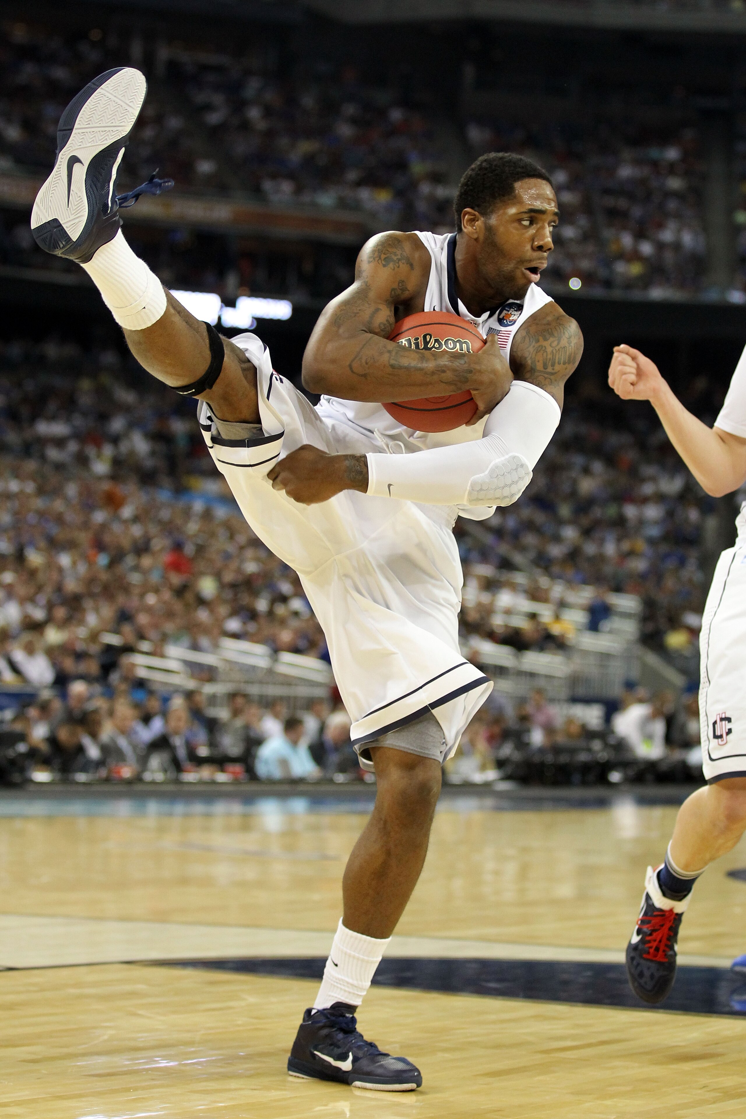 HOUSTON, TX - APRIL 02:  Alex Oriakhi #34 of the Connecticut Huskies pulls down a rebound against the Kentucky Wildcats during the National Semifinal game of the 2011 NCAA Division I Men's Basketball Championship at Reliant Stadium on April 2, 2011 in Hou
