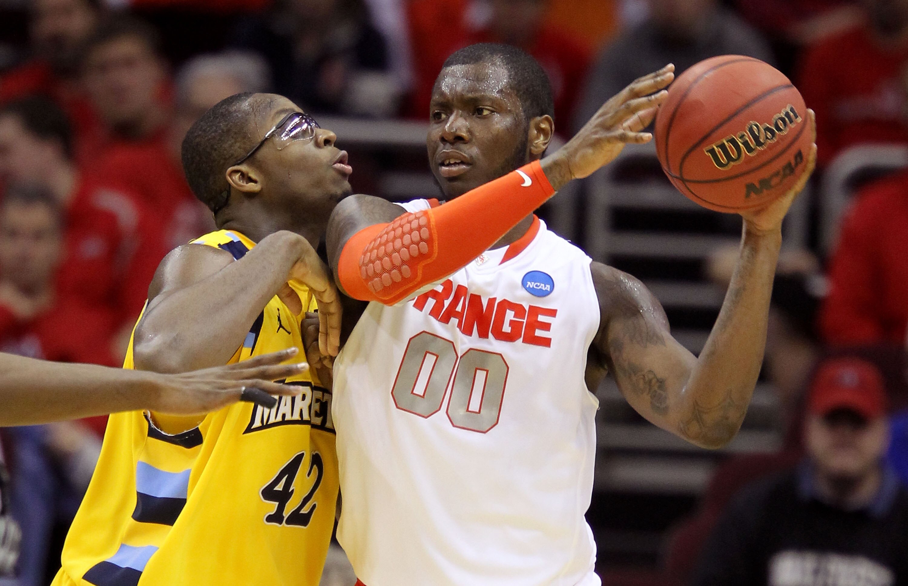 CLEVELAND, OH - MARCH 20: Rick Jackson #00 of the Syracuse Orange handles the ball against Chris Otule #42 of the Marquette Golden Eagles during the third of the 2011 NCAA men's basketball tournament at Quicken Loans Arena on March 20, 2011 in Cleveland,