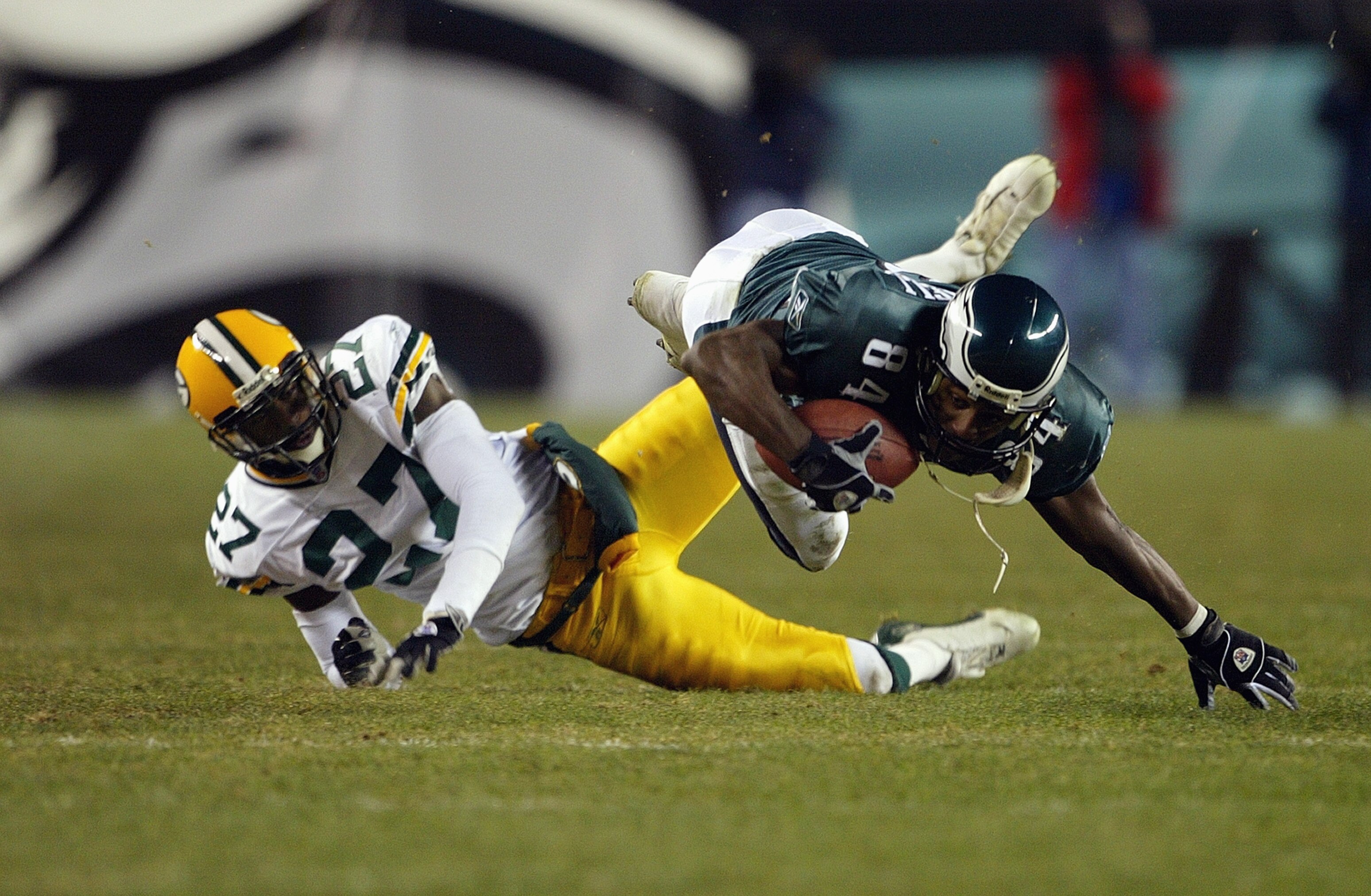 PHILADELPHIA - JANUARY 11:  Wide receiver Freddie Mitchell #84 of the Philadelphia Eagles catches a first down pass on defensive back Michael Hawthorne #27 of the Green Bay Packers on the Eagles last posession in the forth quarter during the NFC divisiona