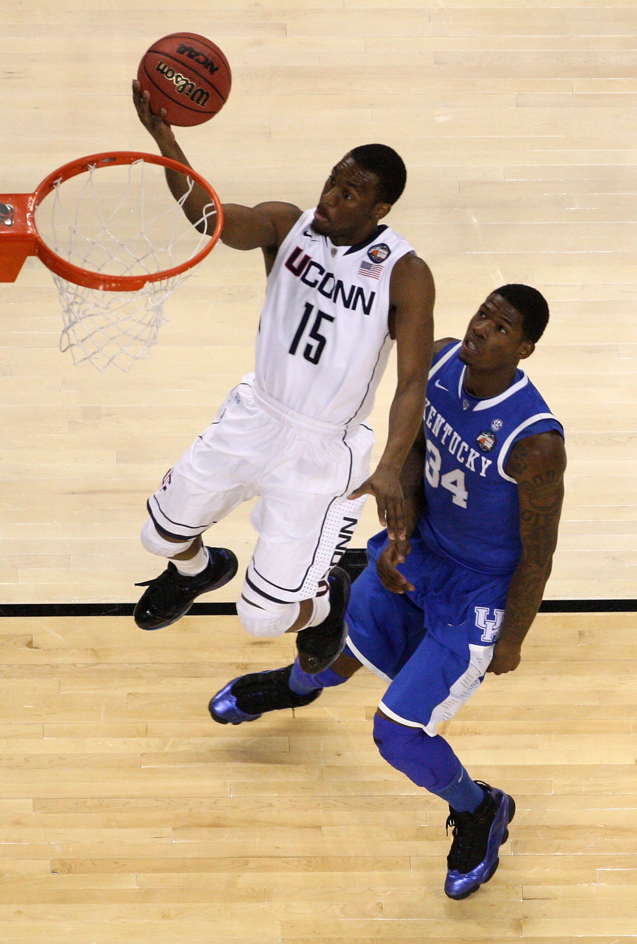 HOUSTON, TX - APRIL 02:  Kemba Walker #15 of the Connecticut Huskies goes to the basket against DeAndre Liggins #34 of the Kentucky Wildcats during the National Semifinal game of the 2011 NCAA Division I Men's Basketball Championship at Reliant Stadium on