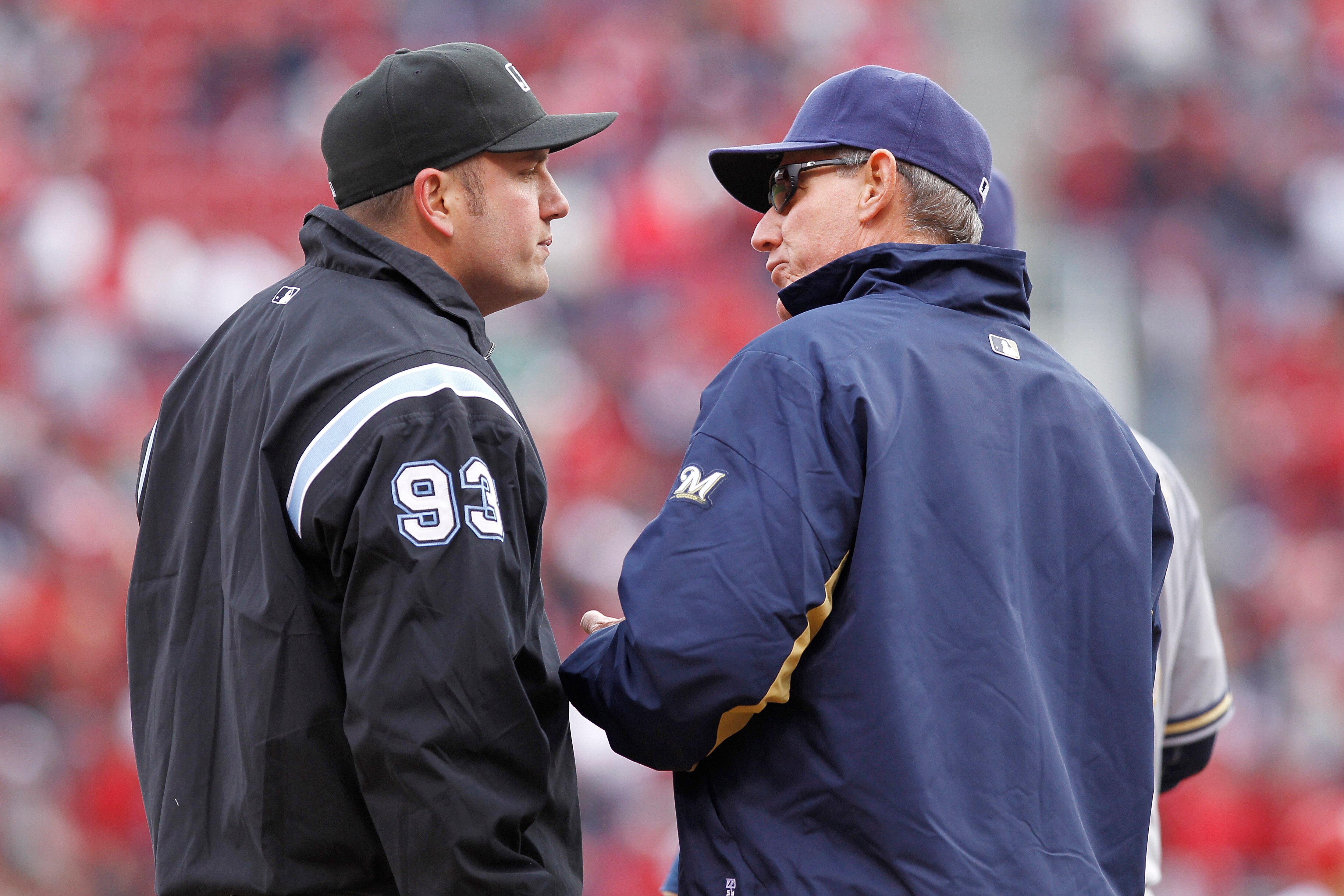 CINCINNATI, OH - MARCH 31: Milwaukee Brewers manager Ron Roenicke argues with third base umpire Dan Bellino after Casey McGehee missed a tag on Brandon Phillips of the Cincinnati Reds in the opening day game at Great American Ballpark on March 31, 2011 in