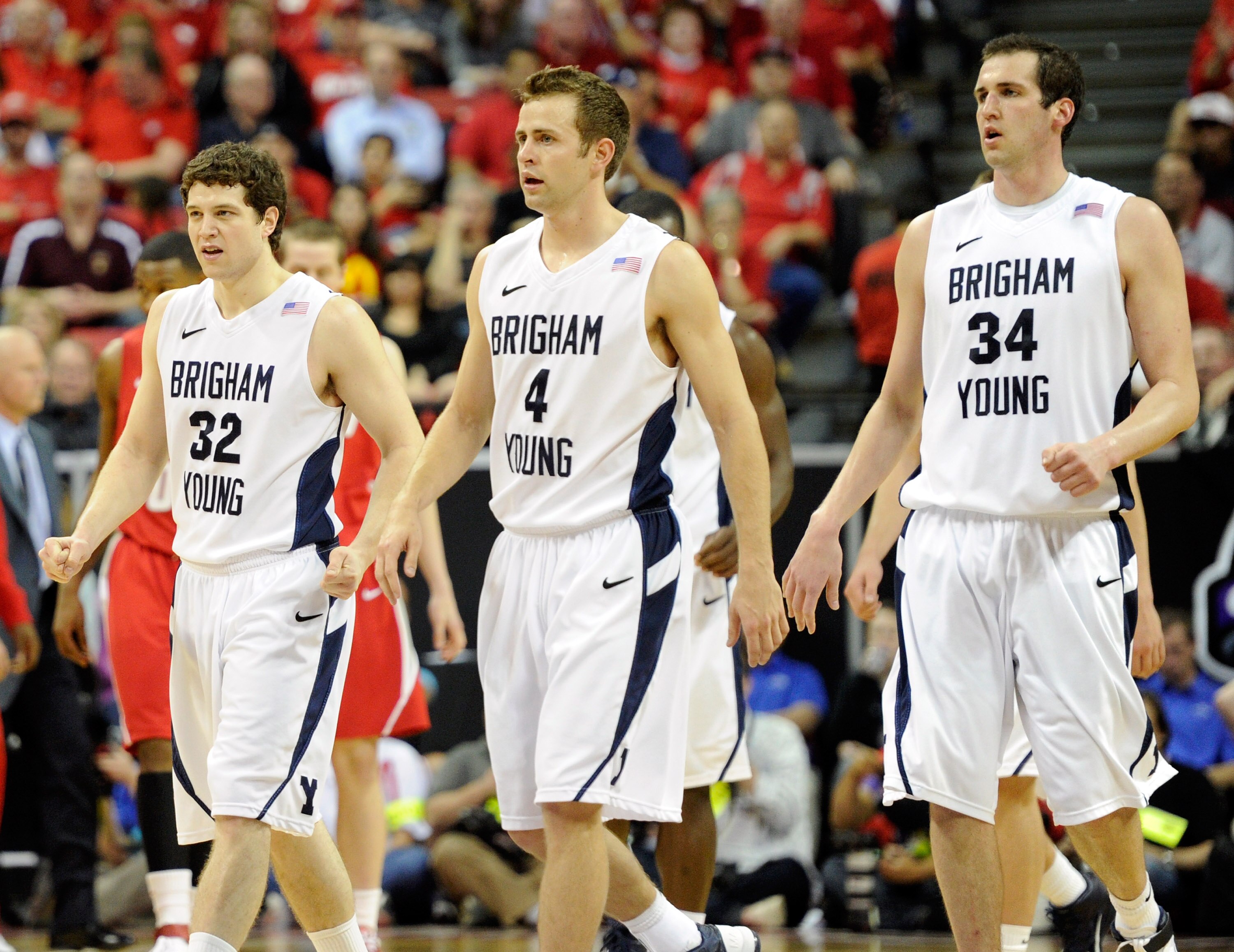 LAS VEGAS, NV - MARCH 11:  Jimmer Fredette #32, Jackson Emery #4 and Noah Hartsock #34 of the Brigham Young University Cougars walk to the bench during a timeout in a semifinal game of the Conoco Mountain West Conference Basketball tournament against the