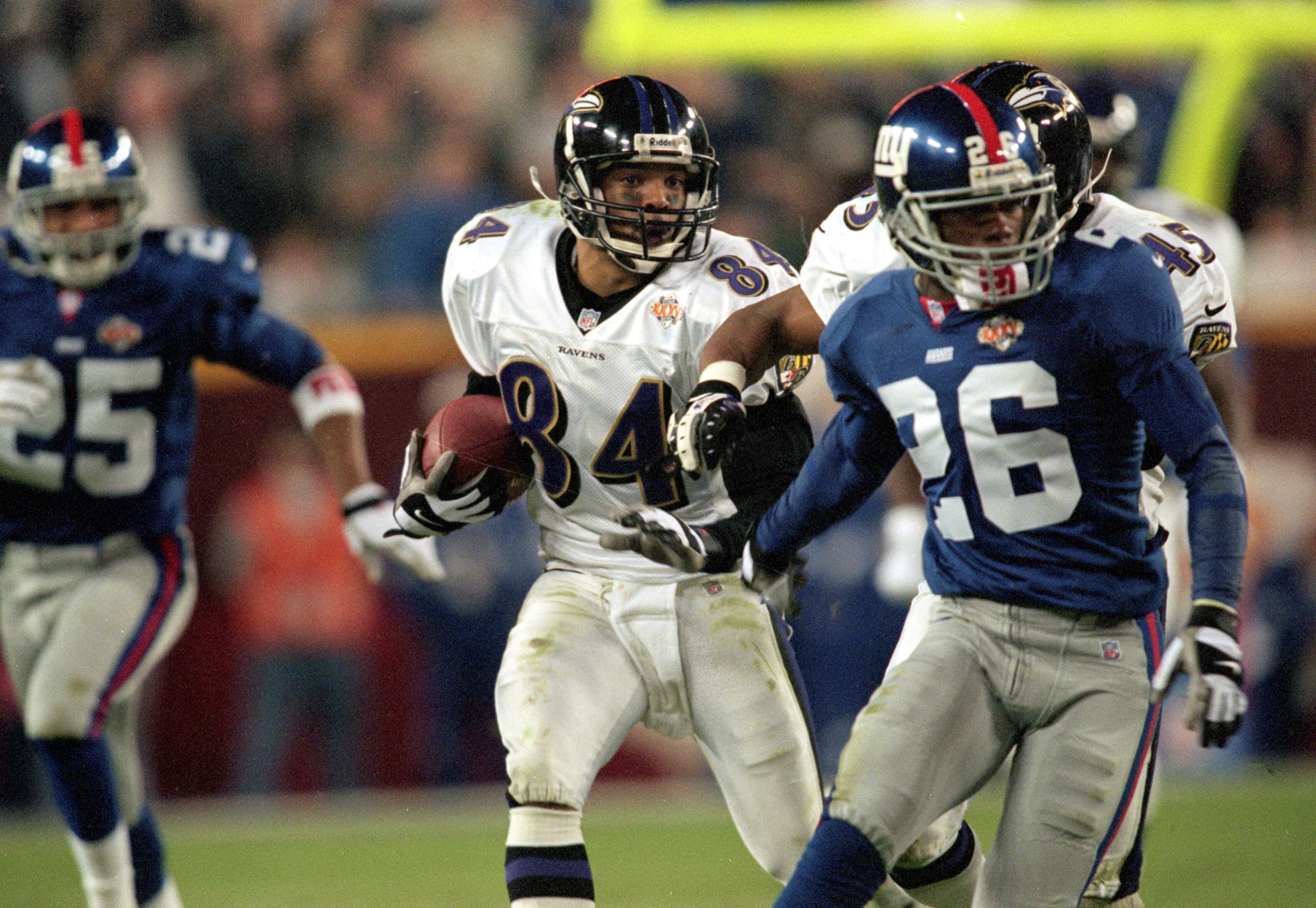 28 Jan 2001:  Jermaine Lewis #84 of the Baltimore Ravens runs with the ball for a run back touchdown during the Super Bowl XXXV Game against the New York Giants at the Raymond James Stadium in Tampa, Florida. The Ravens defeated the Giants 34-7. Mandatory