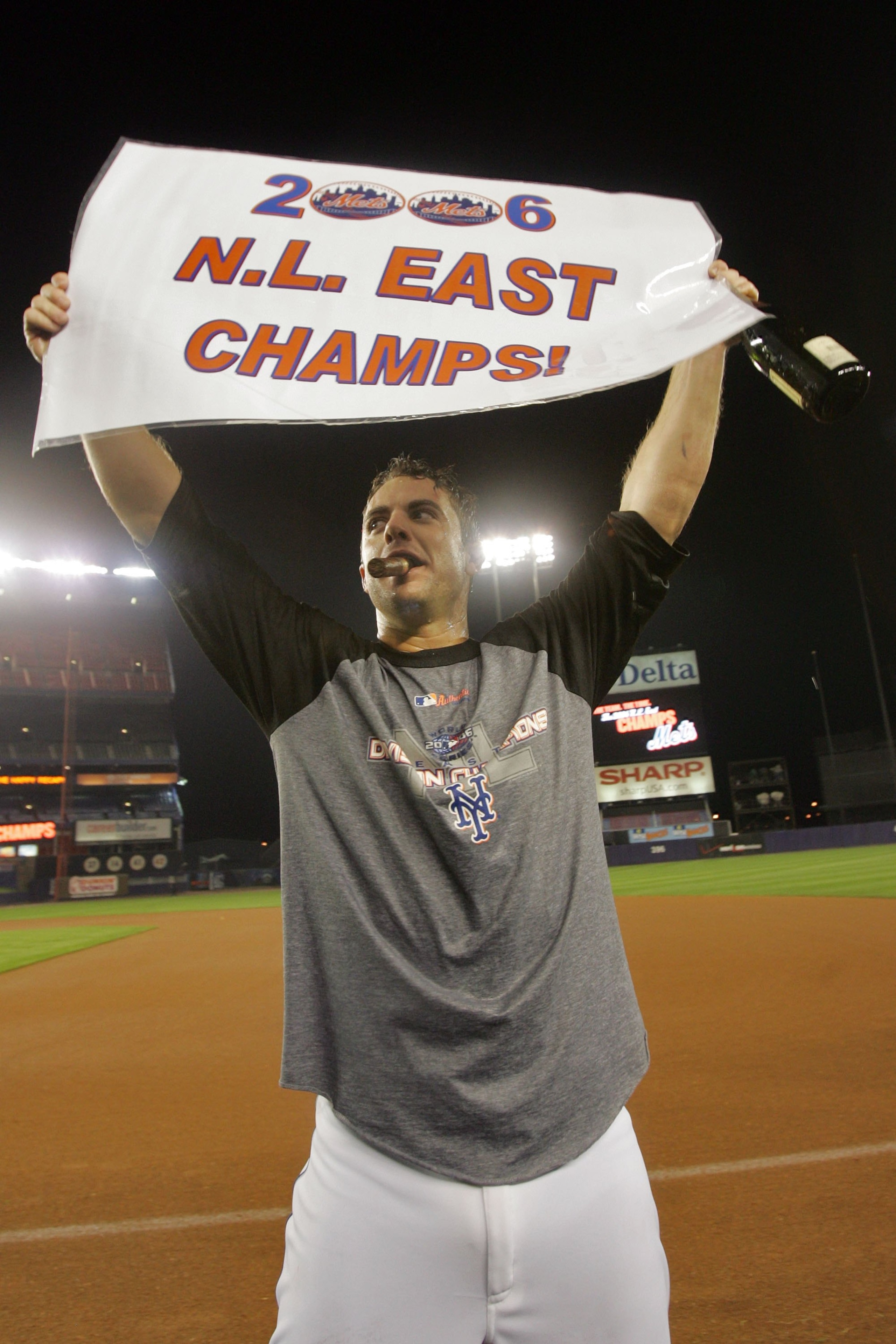 NEW YORK - SEPTEMBER 18:  David Wright #5 of the New York Mets holds up a sign reading '2006 N.L. East Champs' after beating the Florida Marlins on September 18, 2006 at Shea Stadium in the Flushing neighborhood of the Queens borough of New York City.  Wi