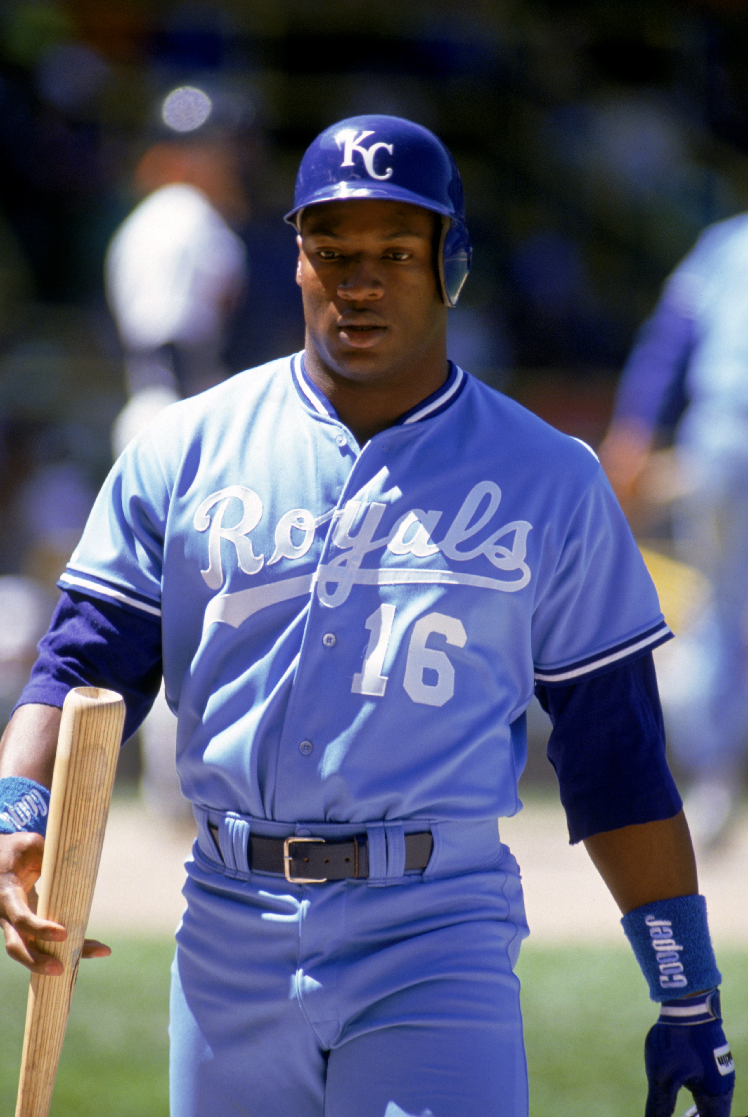 1990:  Bo Jackson #16 of the Kansas City Royals walks on the field with his bat on hand during a game in the 1990 season.  (Photo by Jonathan Daniel/Getty Images)