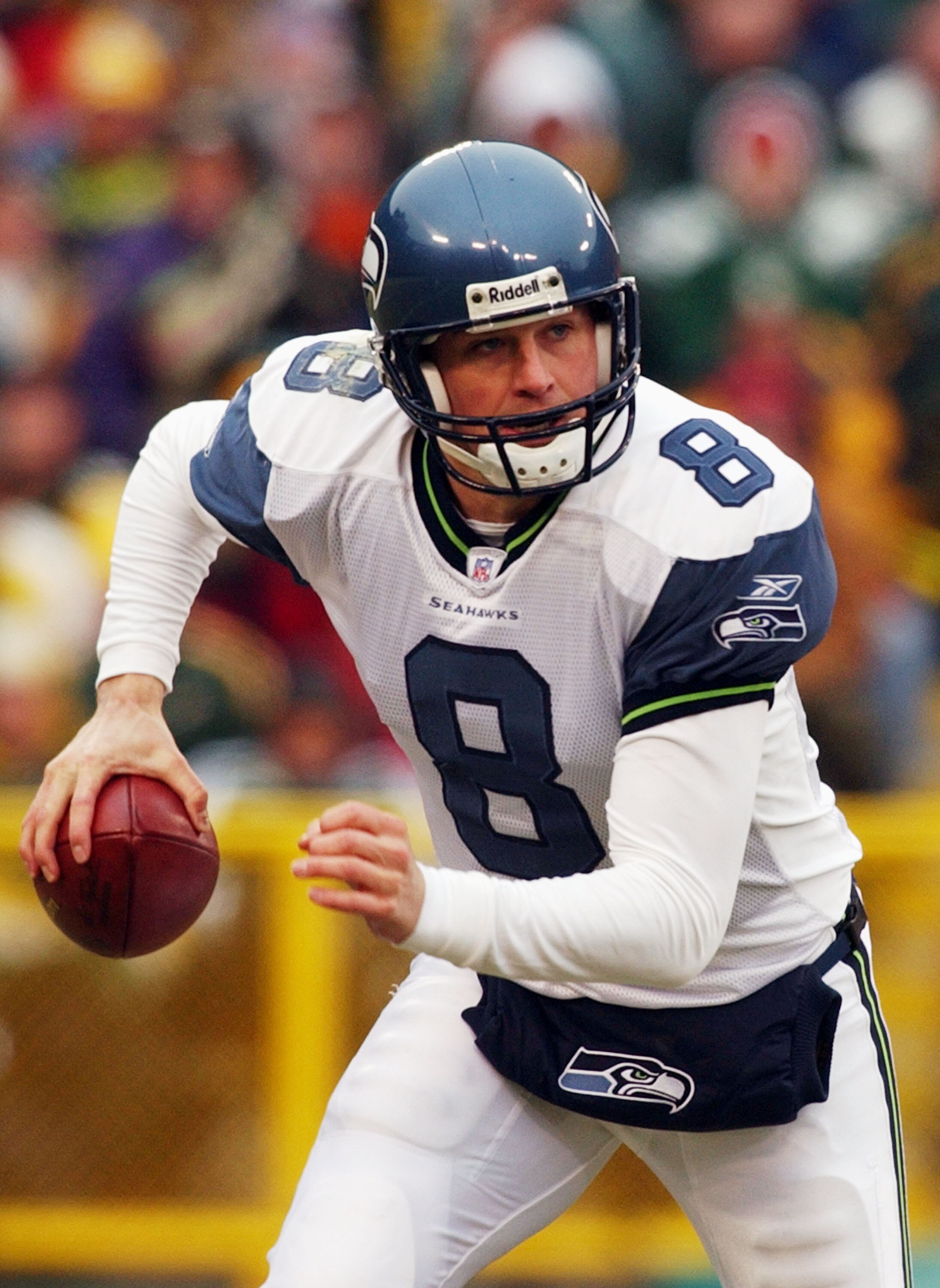 GREEN BAY, WI - JANUARY 4:  Quarterback Matt Hasselbeck #8 of the Seattle Seahawks rolls out looking for a receiver against the Green Bay Packers during a game on January 4, 2004 at Lambeau Field in Green Bay, Wisconsin. (Photo by Jonathan Daniel/Getty Im