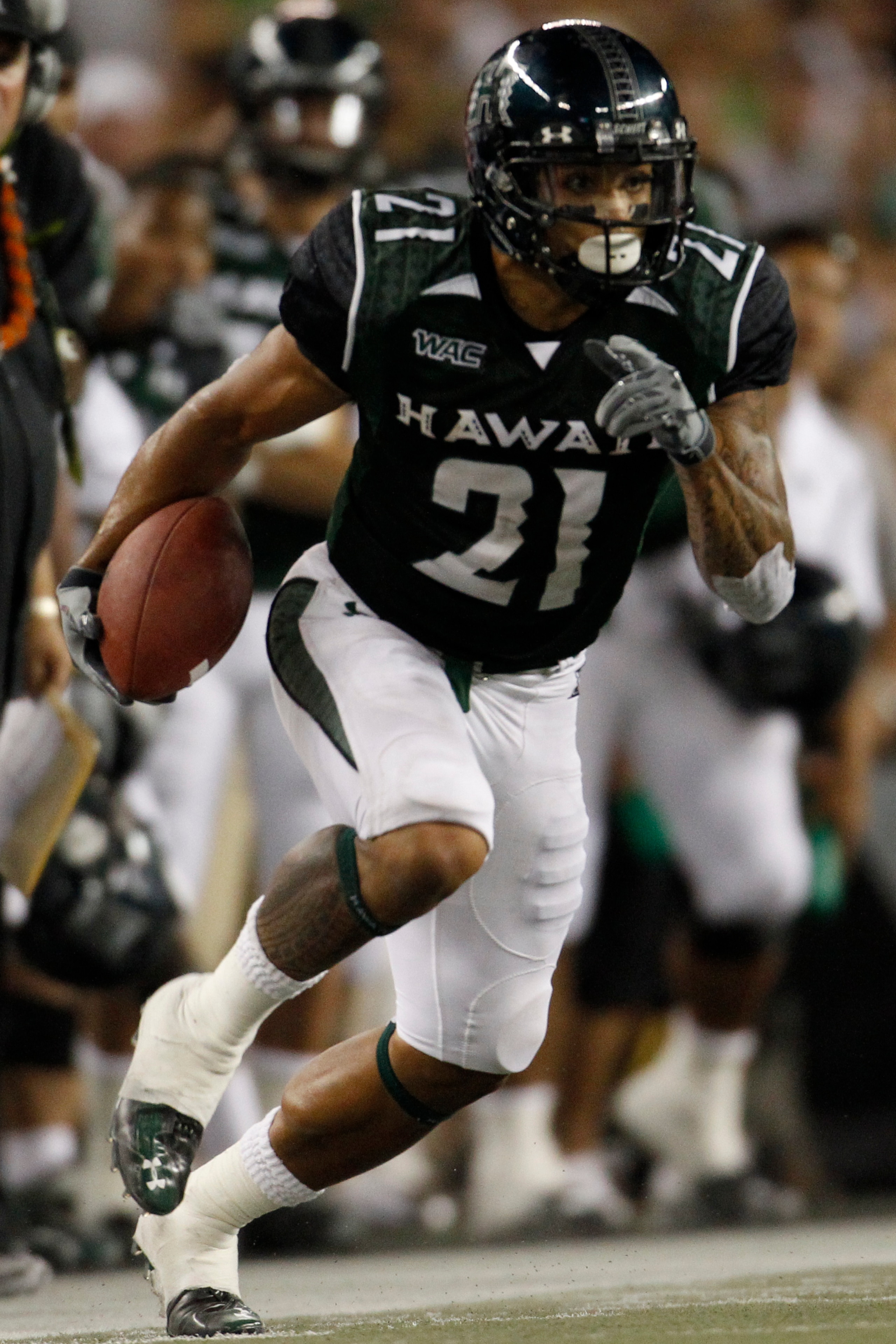 HONOLULU - SEPTEMBER 2: Kealoha Pilares #21 of the University of Hawaii Warriors  runs the ball during second half action at Aloha Stadium September 2, 2010 in Honolulu, Hawaii. (Photo by Kent Nishimura/Getty Images)