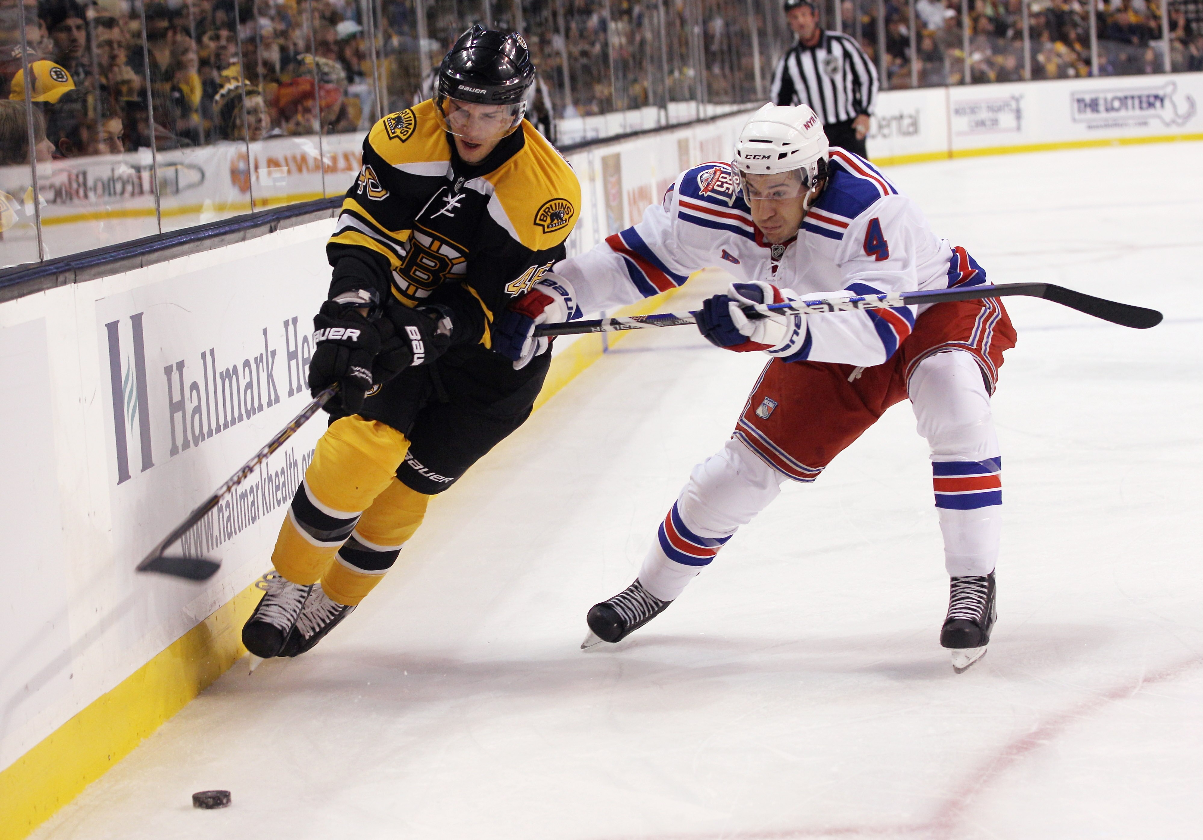 BOSTON - OCTOBER 23: Michael Del Zotto #4  of the New York Rangers checks David Krejci #46 of the Boston Bruins at the TD Garden on October 23, 2010 in Boston, Massachusetts. The Rangers defeated the Bruins 3-2. (Photo by Bruce Bennett/Getty Images)