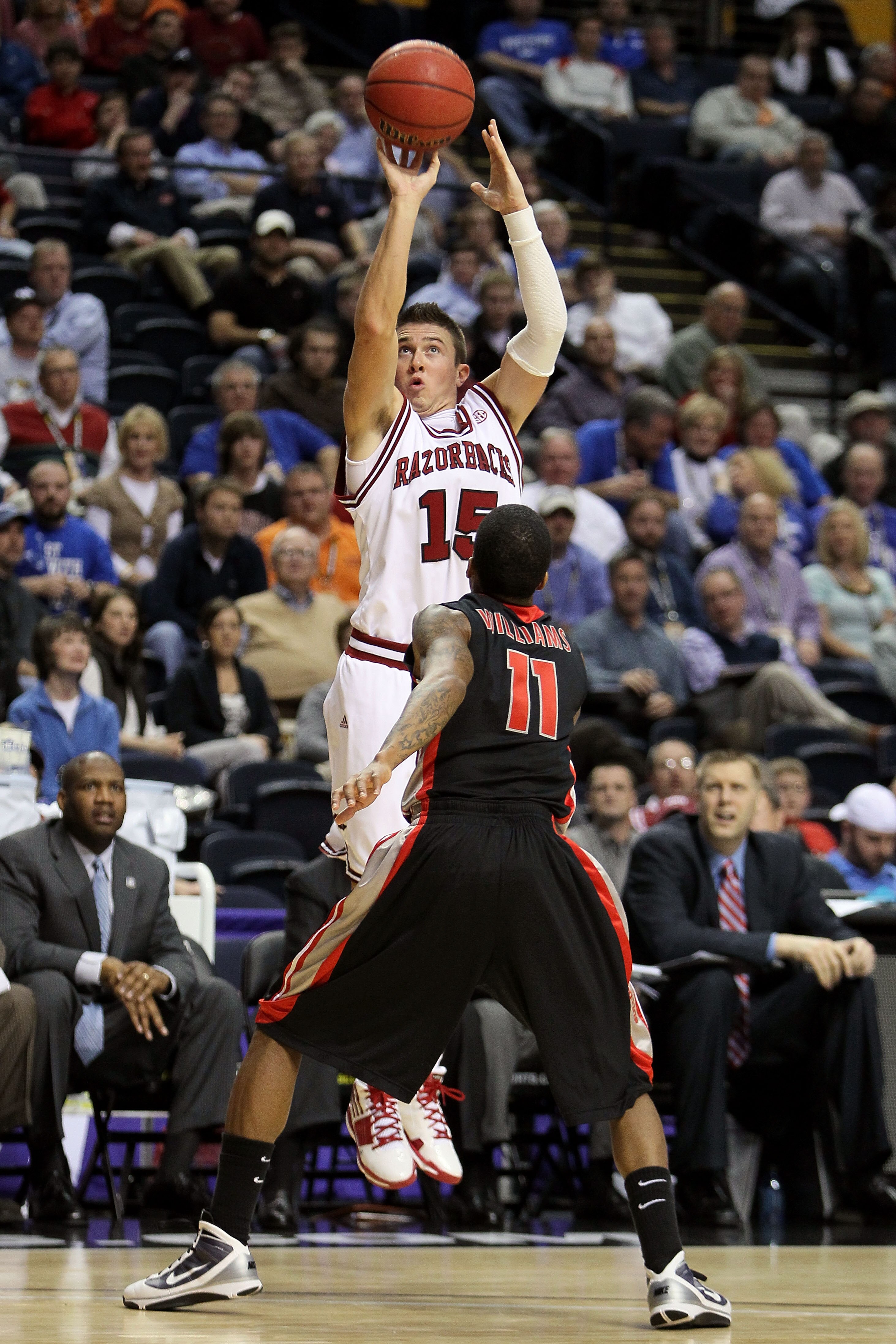 NASHVILLE, TN - MARCH 11:  Rotonei Clarke #15 of the Arkanasas Razorbacks attempts a shot against Vincent Williams #11 of the Georgia Bulldogs during the first round of the SEC Men's Basketball Tournament at the Bridgestone Arena on March 11, 2010 in Nash