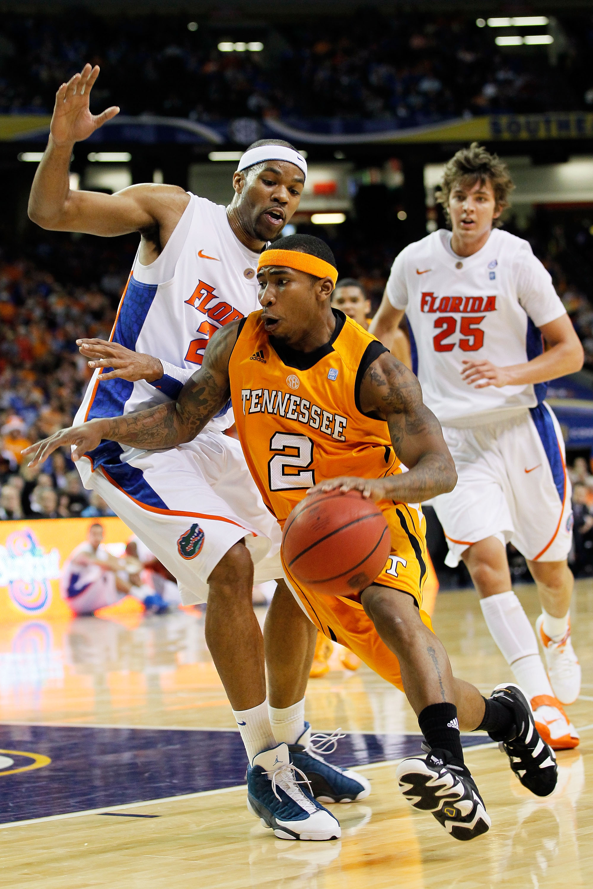 ATLANTA, GA - MARCH 11:  Melvin Goins #2 of the Tennessee Volunteers drives down court past Alex Tyus #23 and Chandler Parsons #25 of the Florida Gators during the quarterfinals of the SEC Men's Basketball Tournament at Georgia Dome on March 11, 2011 in A