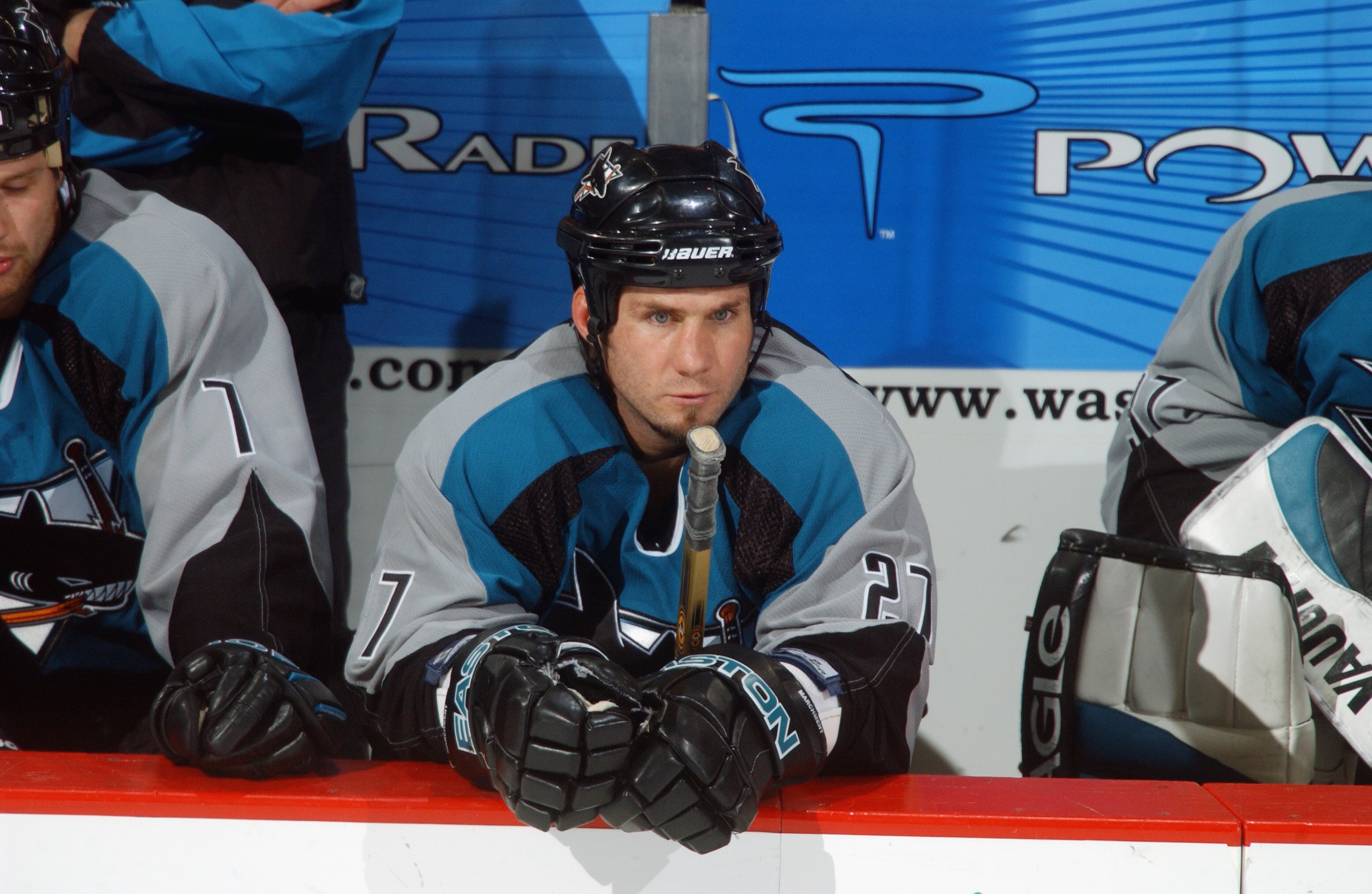 WASHINGTON - NOVEMBER 19:  Defenseman Bryan Marchment #27 of the San Jose Sharks looks on from the bench against the Washington Capitals during the NHL game at the MCI Center on November 19, 2002 in Washington D.C.  The Sharks won 3-2.  (Photo By Mitchell