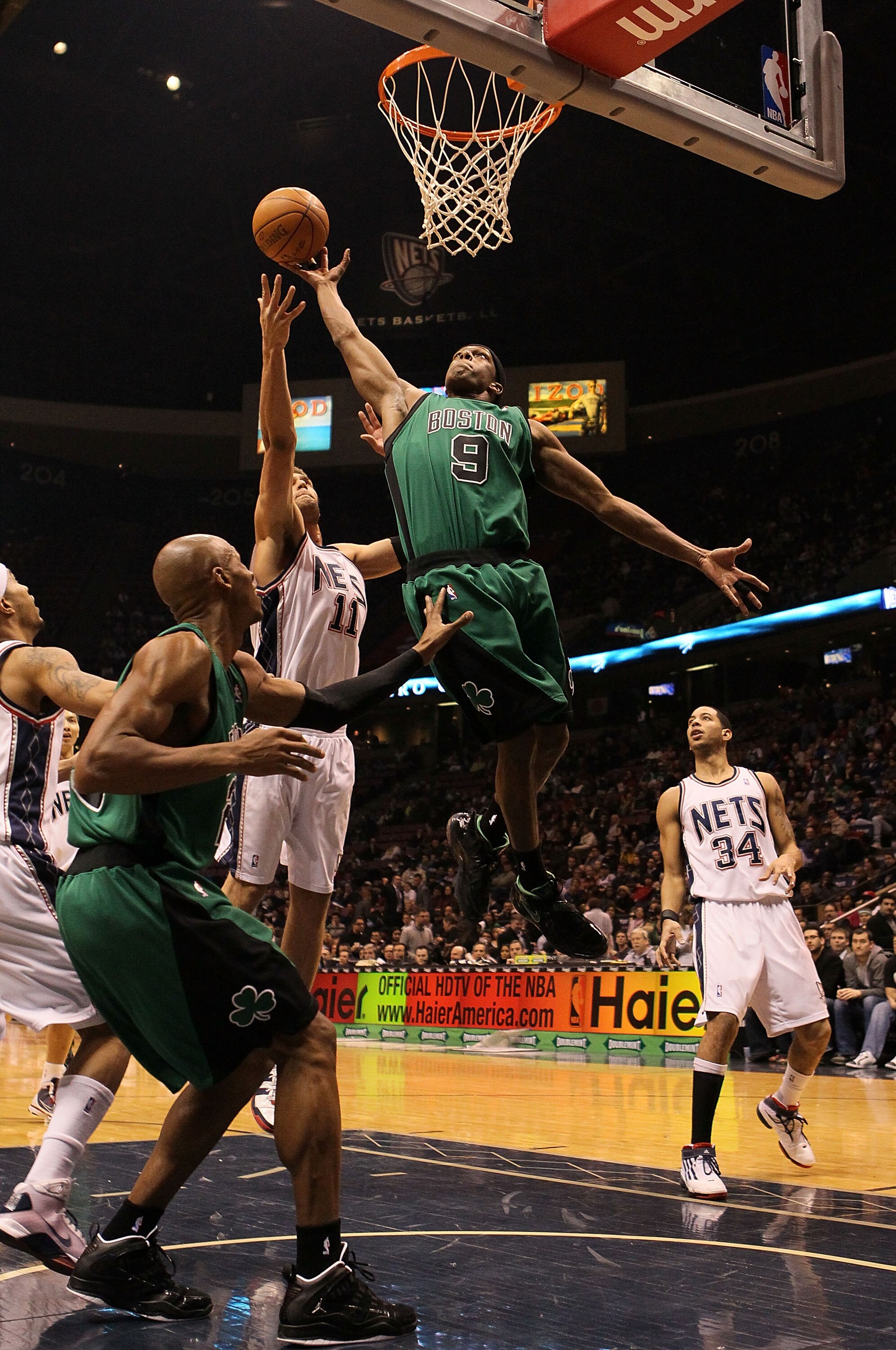 EAST RUTHERFORD, NJ - JANUARY 13:  Rajon Rondo #9  of the Boston Celtics grabs a rebound against the New Jersey Nets during their game on January 13th, 2010 at The Izod Center in East Rutherford, New Jersey. NOTE TO USER: User expressly acknowledges and a