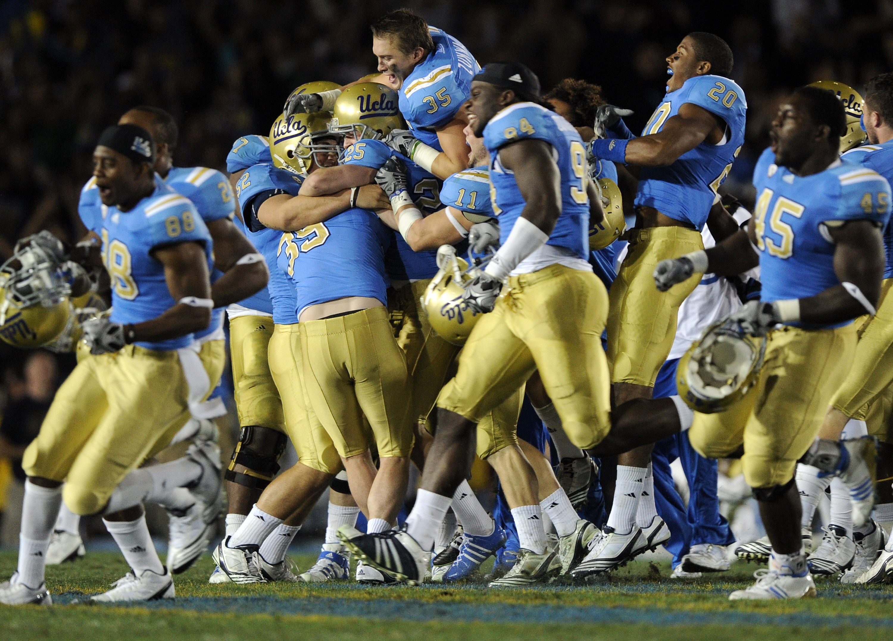 PASADENA, CA - NOVEMBER 06:  Kai Forbath #25 of the UCLA Bruins is hugged by his teammates in celebration of a last second field goal to win the game 17-14 over the Oregon State Beavers during the fourth quarter at the Rose Bowl on November 6, 2010 in Pas