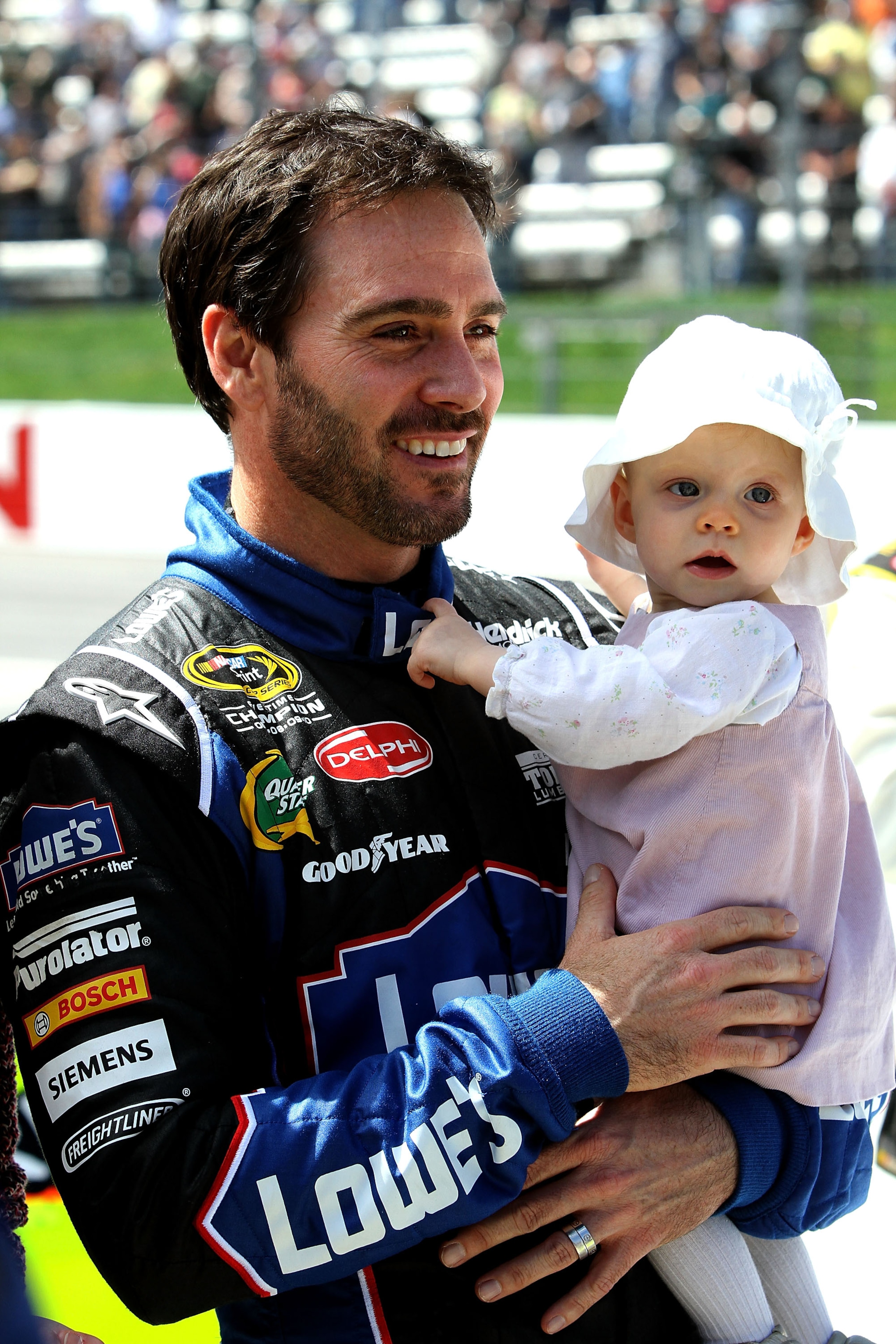 MARTINSVILLE, VA - APRIL 03: Jimmie Johnson, driver of the #48 Lowe's Chevrolet, holds his daughter Genevieve Marie on the grid during prerace for the NASCAR Sprint Cup Series Goody's Fast Relief 500 at Martinsville Speedway on April 3, 2011 in Martinsvil