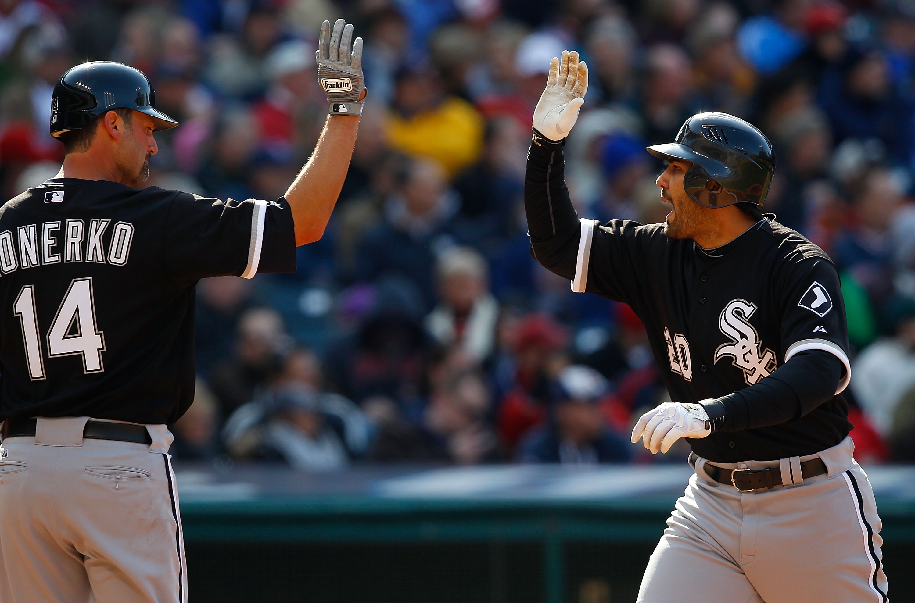 CLEVELAND - APRIL 01:  Carlos Quentin #20 celebrates with teammate aul Konerko #14 of the Chicago White Sox after hitting a two-run home run during the Opening Day game against the Cleveland Indians on April 1, 2011 at Progressive Field in Cleveland, Ohio