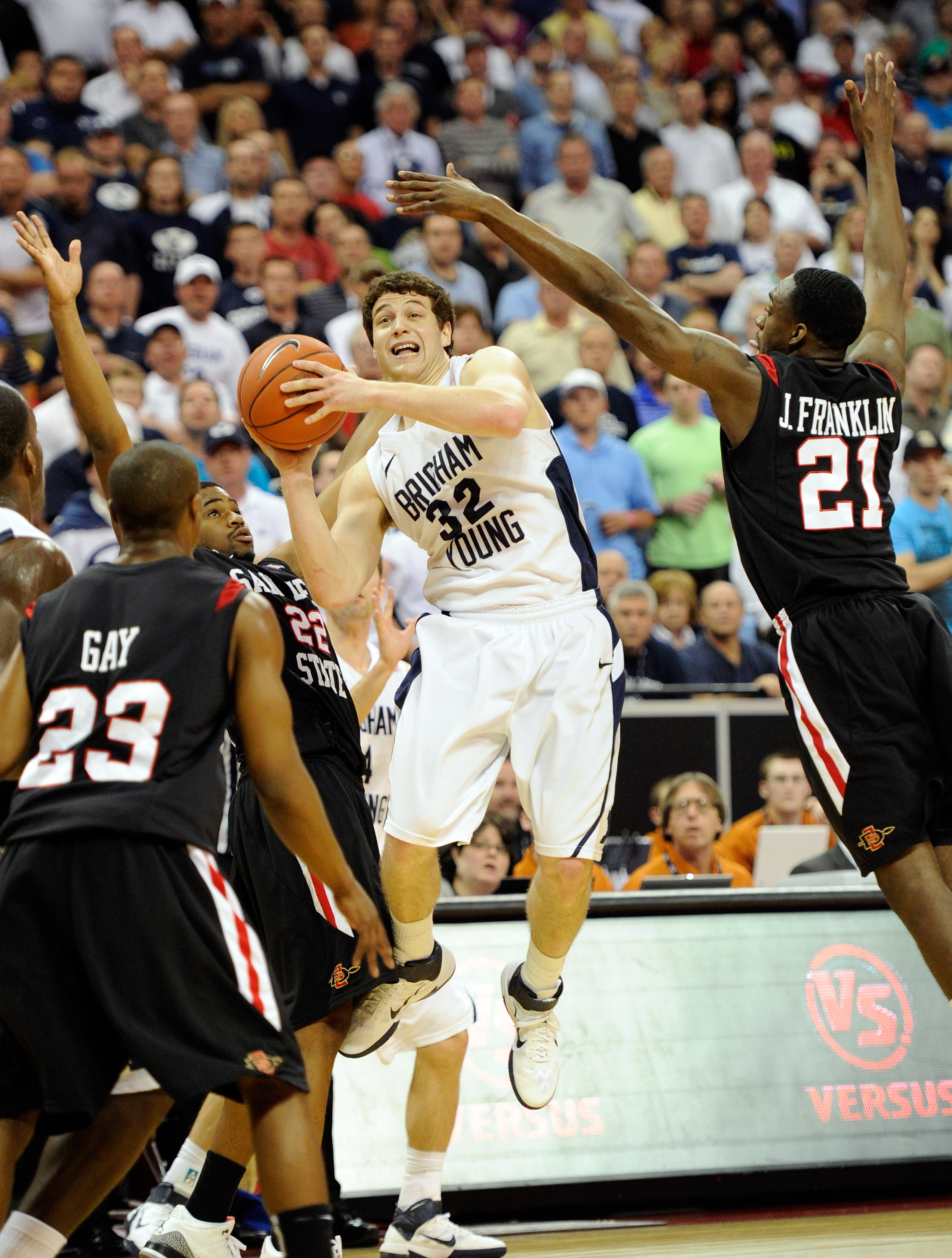 LAS VEGAS, NV - MARCH 12:  Jimmer Fredette #32 of the Brigham Young University Cougars shoots against D.J. Gay #23, Chase Tapley #22 and Jamaal Franklin #21 of the San Diego State Aztecsduring the championship game of the Conoco Mountain West Conference B