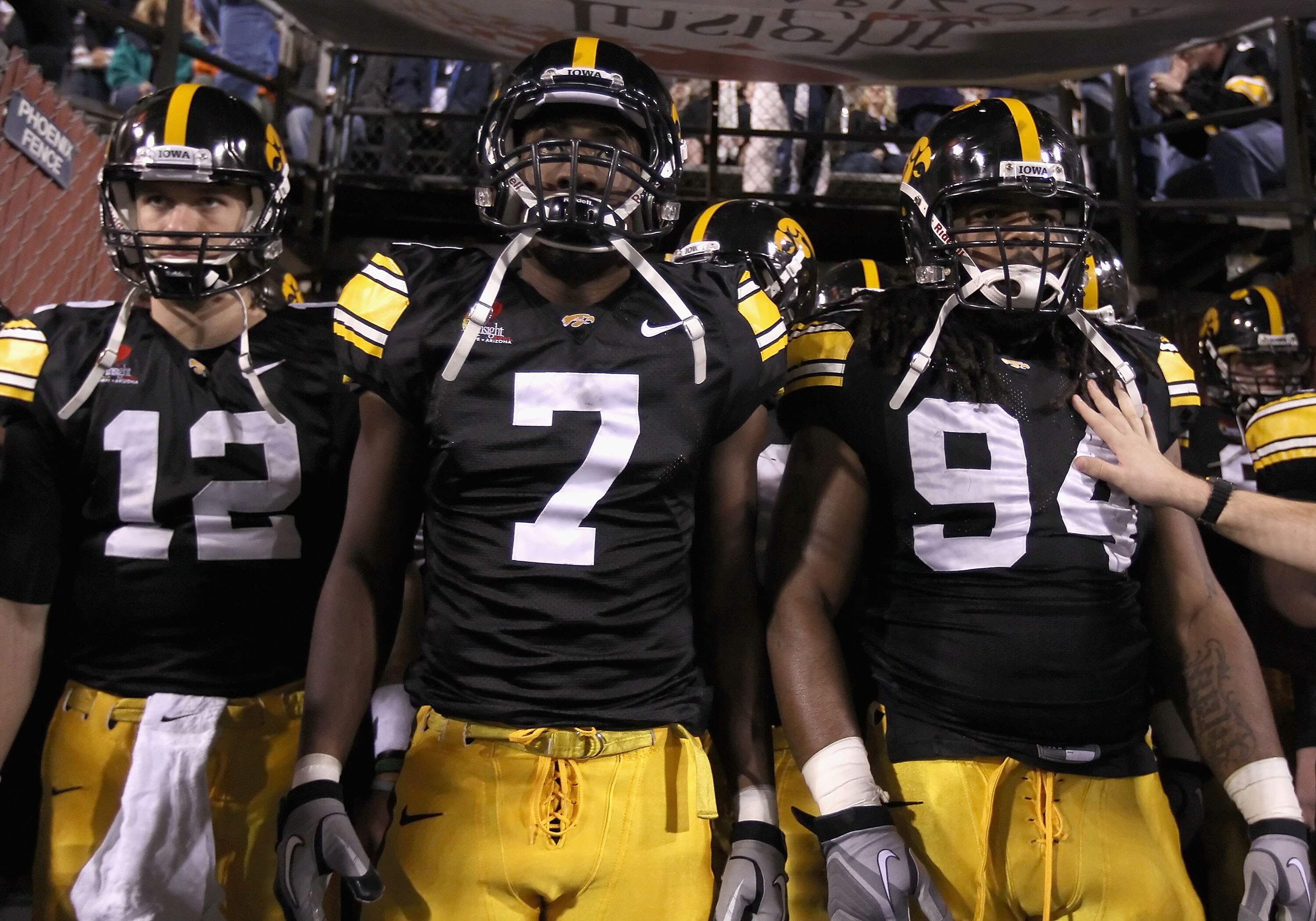 TEMPE, AZ - DECEMBER 28:  (L-R) Ricky Stanzi #12, Marvin McNutt #7 and Adrian Clayborn #94 of the Iowa Hawkeyes walk out onto the field for the Insight Bowl against the Missouri Tigers at Sun Devil Stadium on December 28, 2010 in Tempe, Arizona. The Hawke