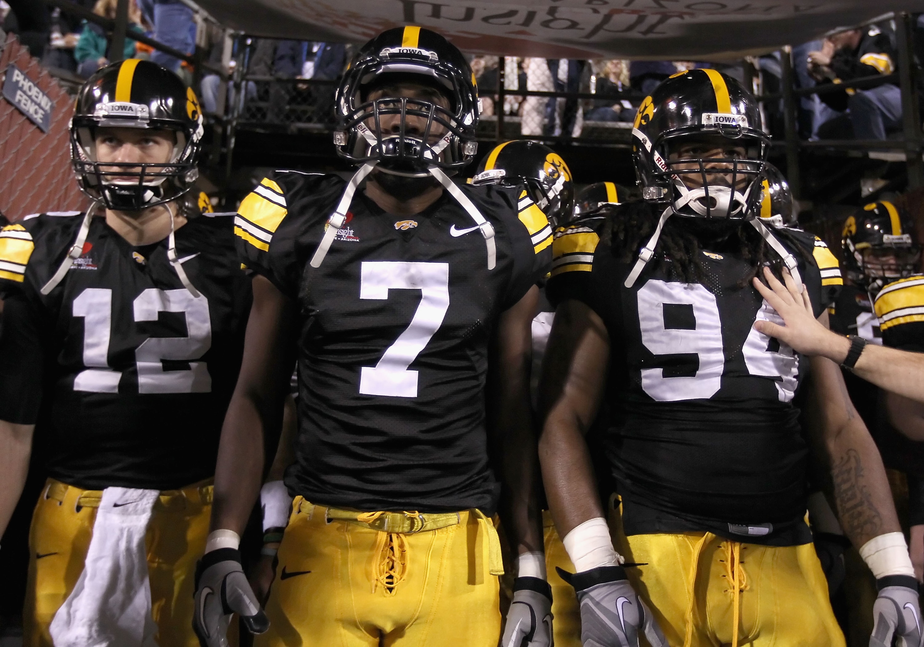 TEMPE, AZ - DECEMBER 28:  (L-R) Ricky Stanzi #12, Marvin McNutt #7 and Adrian Clayborn #94 of the Iowa Hawkeyes walk out onto the field for the Insight Bowl against the Missouri Tigers at Sun Devil Stadium on December 28, 2010 in Tempe, Arizona. The Hawke