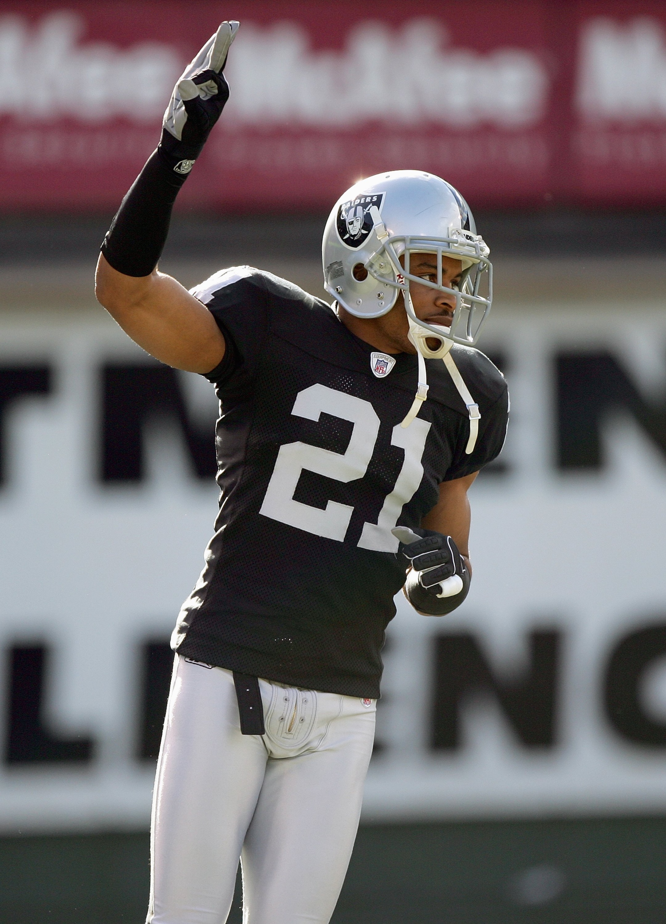 OAKLAND, CA - DECEMBER 17:  Nnamdi Asomugha #21 of the Oakland Raiders signals on the field during an NFL game against the St. Louis Rams at McAfee Coliseum December 17, 2006 in Oakland, California. (Photo by Jed Jacobsohn/Getty Images)