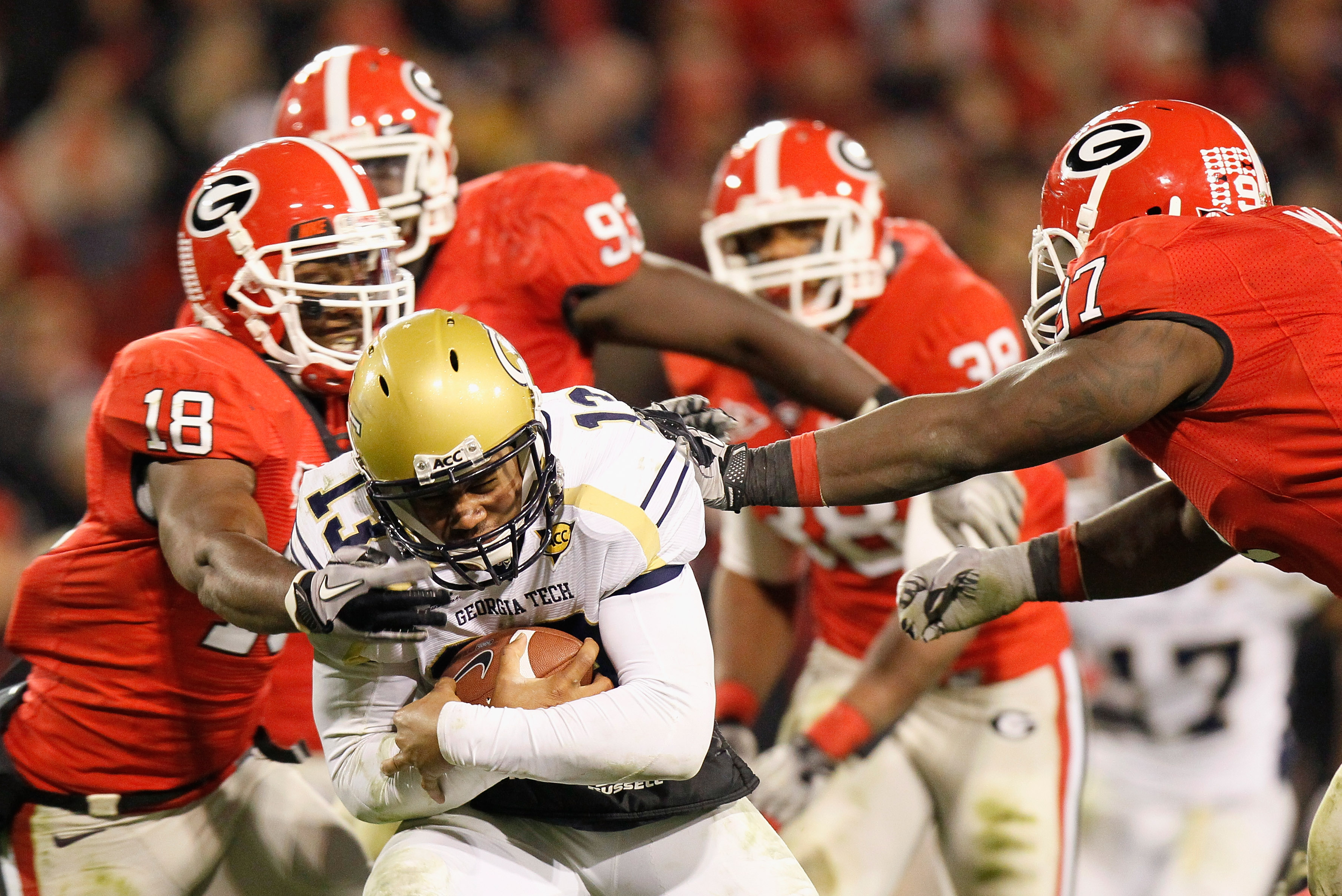 ATHENS, GA - NOVEMBER 27:  Bacarri Rambo #18 and Brandon Wood #97 of the Georgia Bulldogs tackles quarterback Tevin Washington #13 of the Georgia Tech Yellow Jackets at Sanford Stadium on November 27, 2010 in Athens, Georgia.  (Photo by Kevin C. Cox/Getty