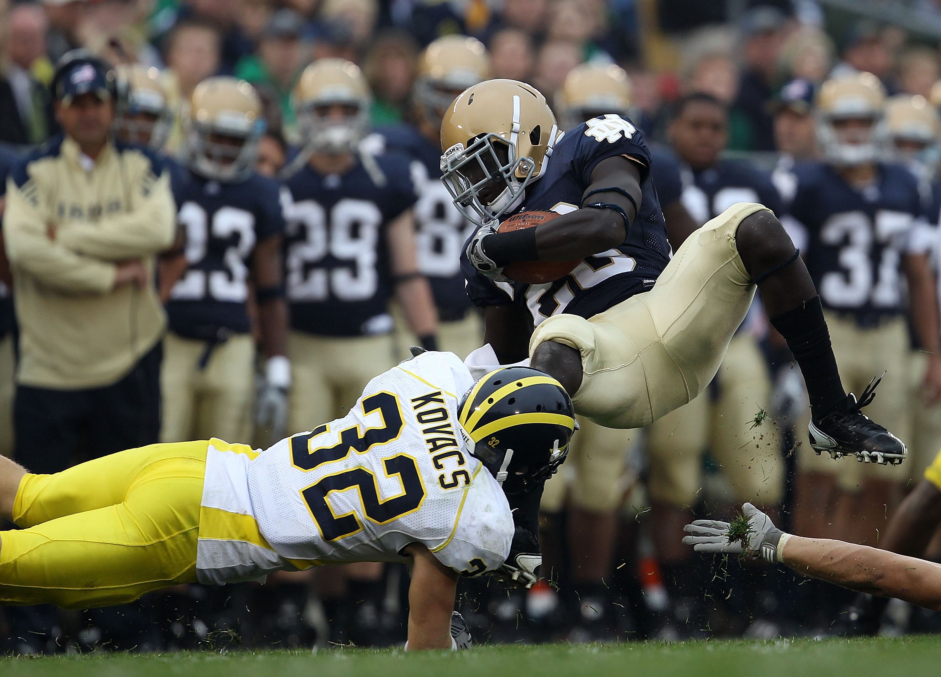 SOUTH BEND, IN - SEPTEMBER 11: Cierre Wood #20 of the Notre Dame Fighting Irish is tackled by Jordan Kovacs #32 of the Michigan Wolverines at Notre Dame Stadium on September 11, 2010 in South Bend, Indiana. Michigan defeated Notre Dame 28-24. (Photo by Jo