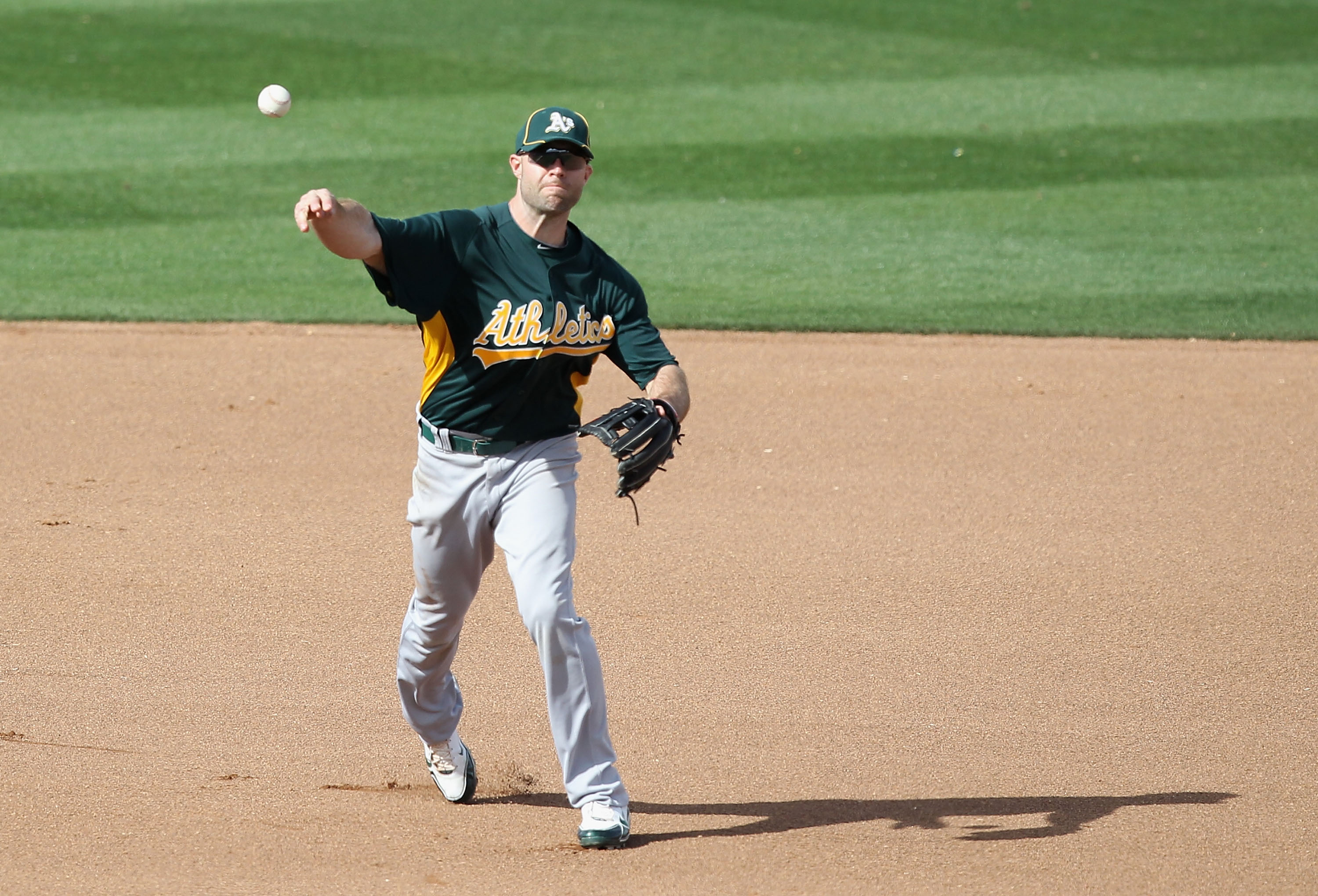 PEORIA, AZ - MARCH 06:  Infielder Kevin Kouzmanoff #5 of the Oakland Athletics fields a ground ball during the spring training game against the San Diego Padres at Peoria Stadium on March 6, 2011 in Peoria, Arizona.  (Photo by Christian Petersen/Getty Ima