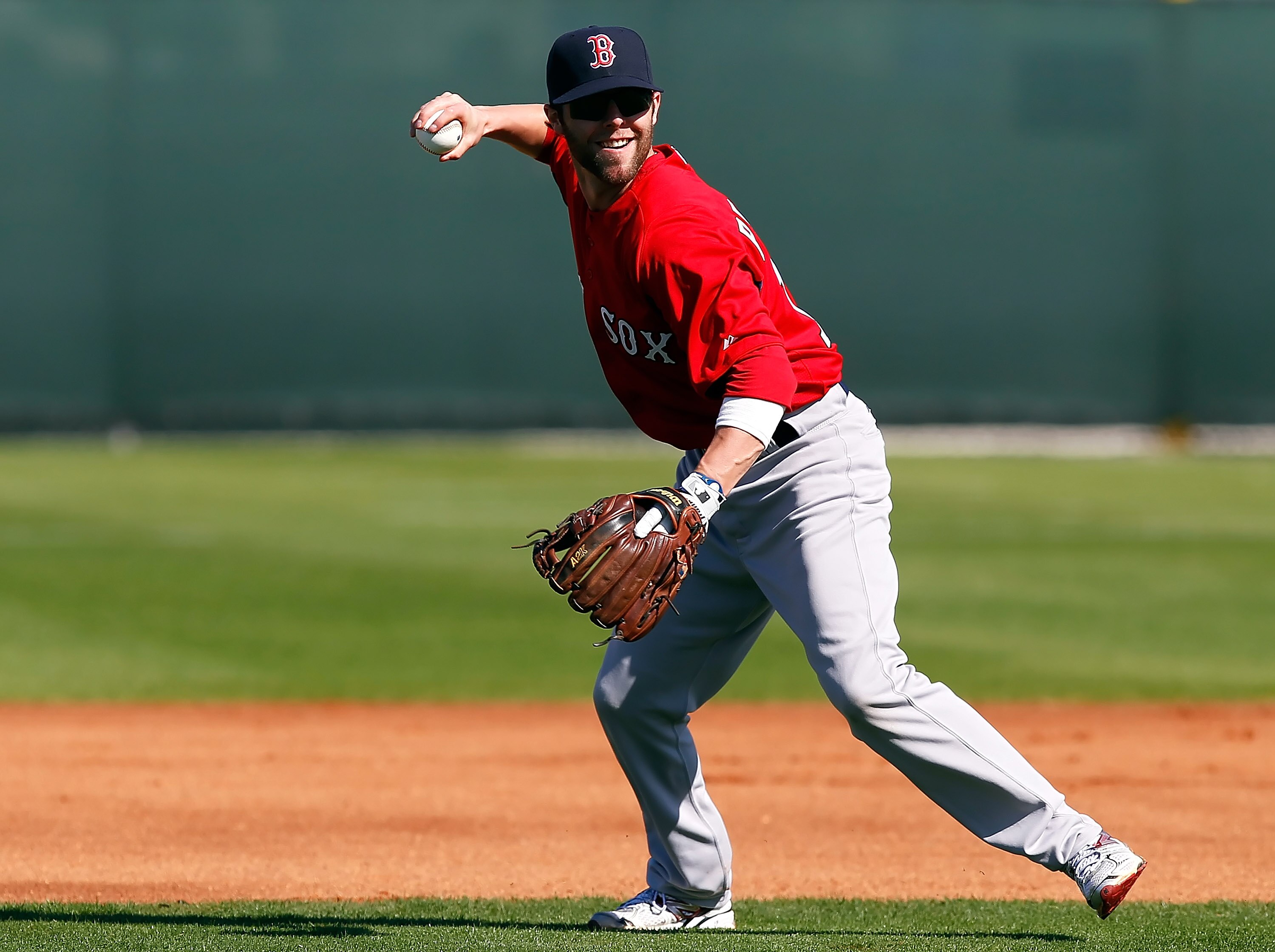 FORT MYERS, FL - FEBRUARY 19:  Infielder Dustin Pedroia #15 of the Boston Red Sox throws home during a Spring Training Workout Session at the Red Sox Player Development Complex on February 19, 2011 in Fort Myers, Florida.  (Photo by J. Meric/Getty Images)