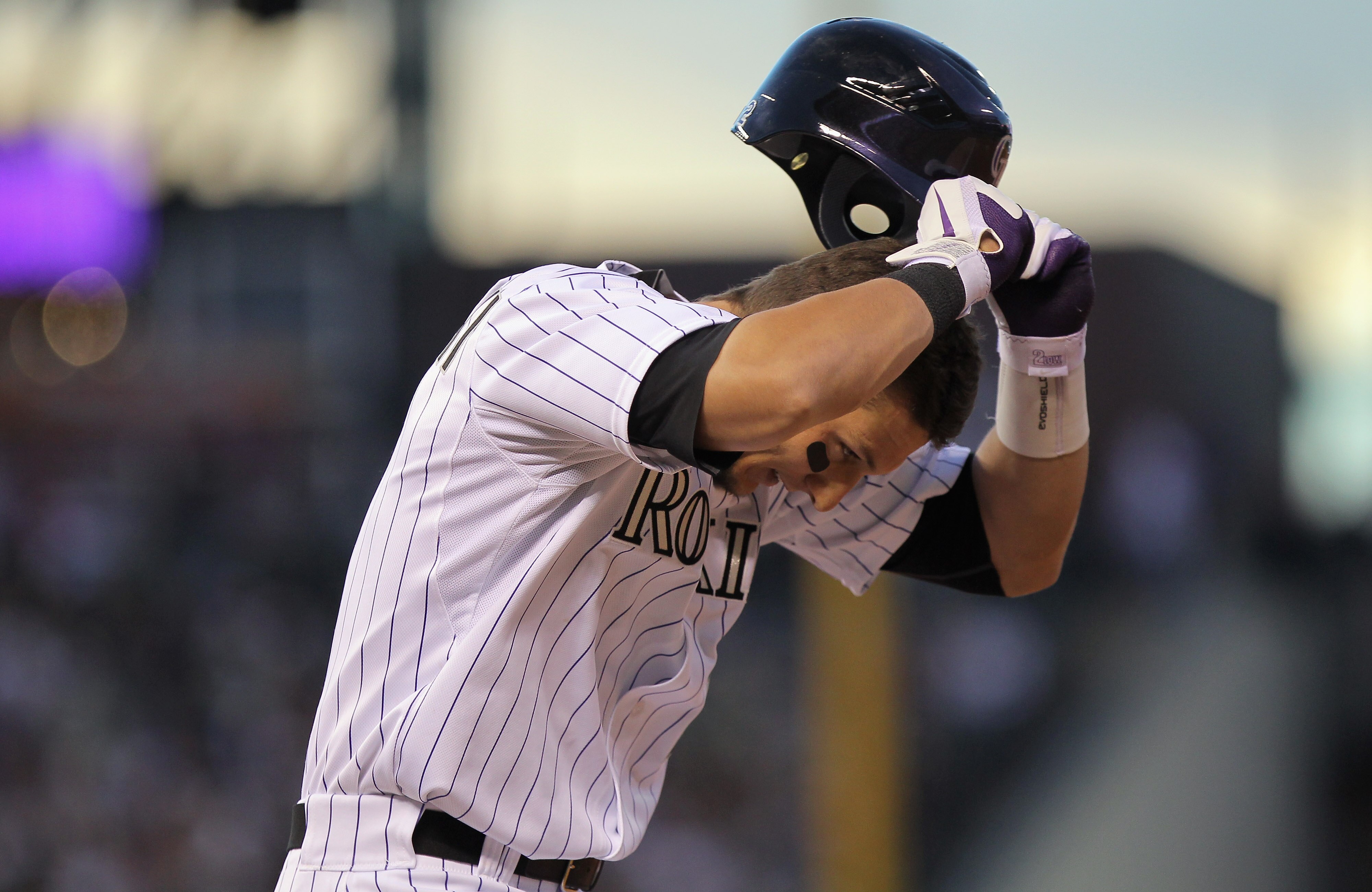 DENVER, CO - APRIL 02:  Shortstop Troy Tulowitzki #2 of the Colorado Rockies tosses his helmet after grounding into a force out to end the third inning against the Arizona Diamondbacks at Coors Field on April 2, 2011 in Denver, Colorado.  (Photo by Doug P